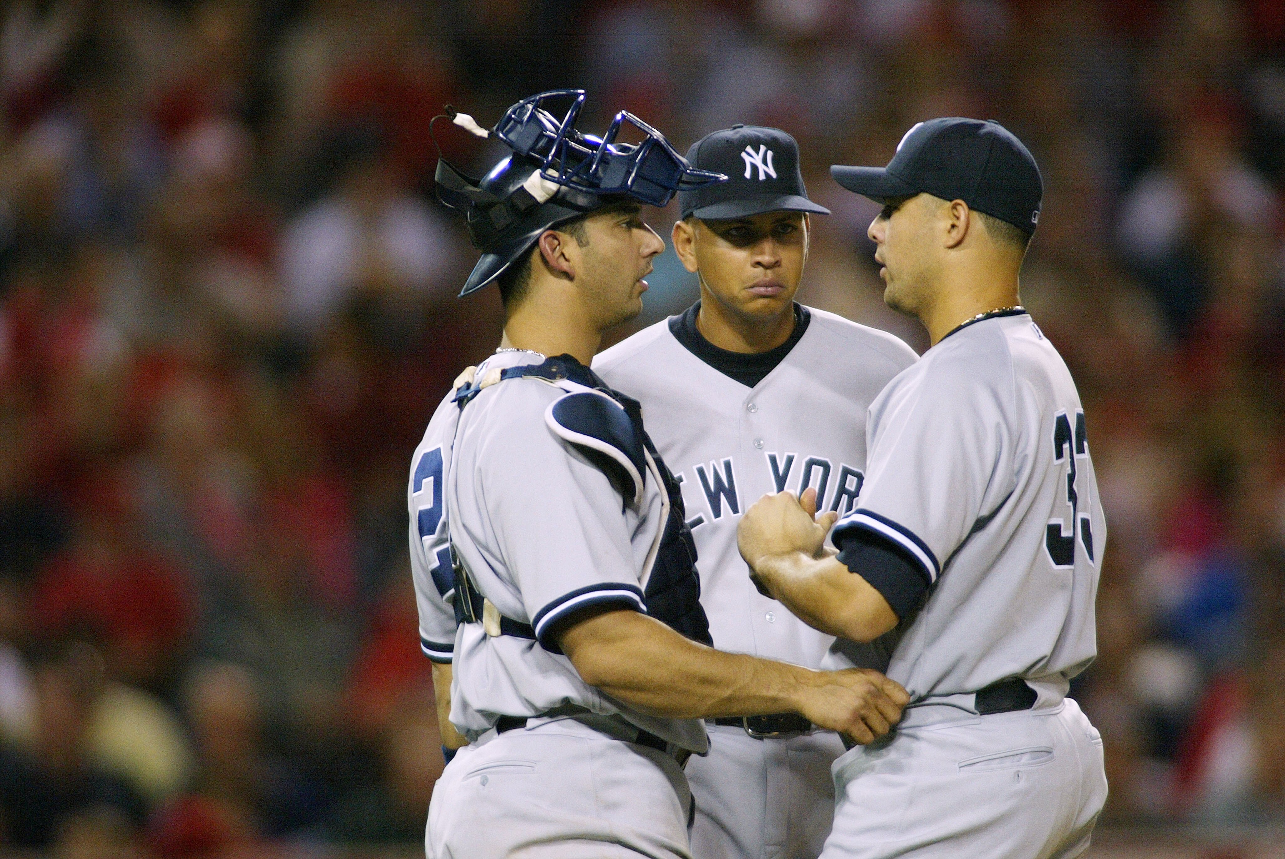 ANAHEIM, CA - MAY 18:   (L-R) Catcher Jorge Posada #20, Alex Rodriguez #13 and pitcher Javier Vasquez #33 of the New York Yankees meet on the mound in the fifth inning against  the Anaheim Angels on May 18, 2004 at Angel Stadium in Anaheim, California.  (