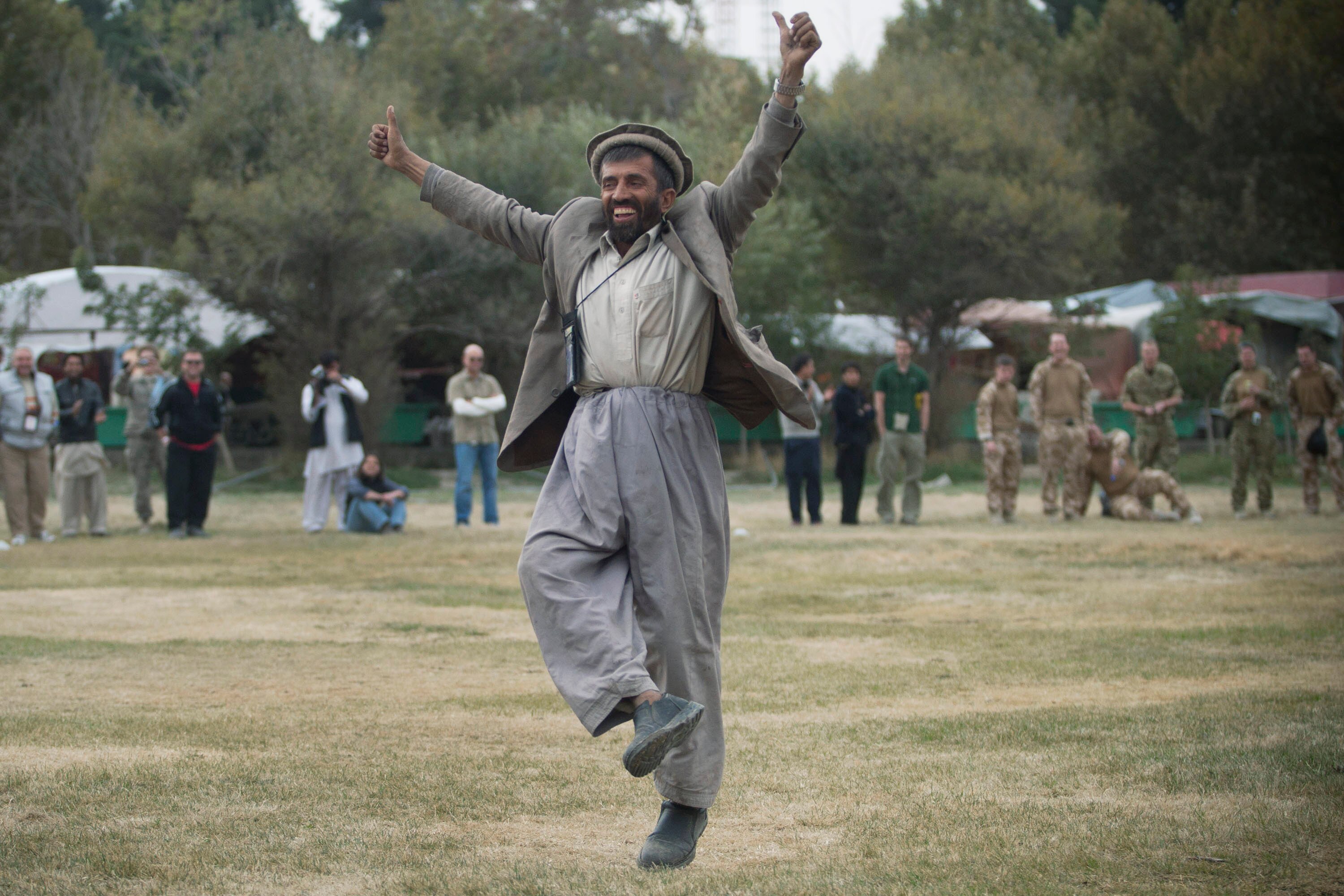 AFGHANISTAN, KABUL - OCTOBER 29:  An Afghan man reacts during a friendly match between the Afghan women's national football team and a team from the NATO-led International Security Assistance Force (ISAF) women's team at the ISAF headquarters in Kabul on