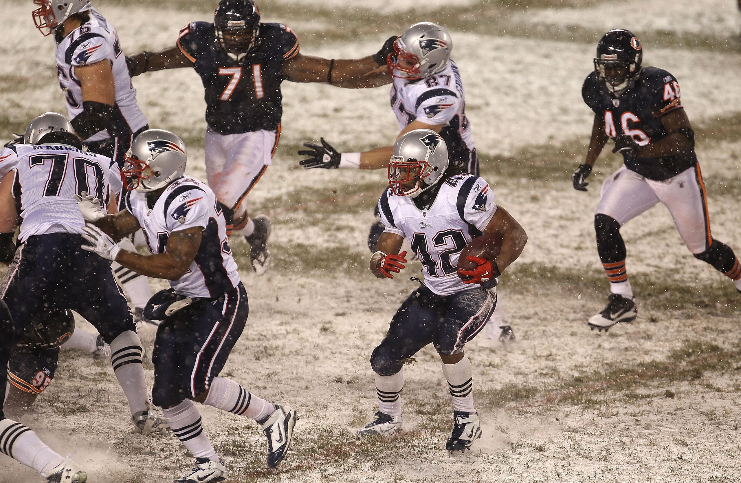 CHICAGO, IL - DECEMBER 12: Ben-Jarvus Green-Ellis #42 of the New England Patriots looks for running room pursued by Israel Idonije #71 and Chris Harris #46 of the Chicago Bears at Soldier Field on December 12, 2010 in Chicago, Illinois. The Patriots defea