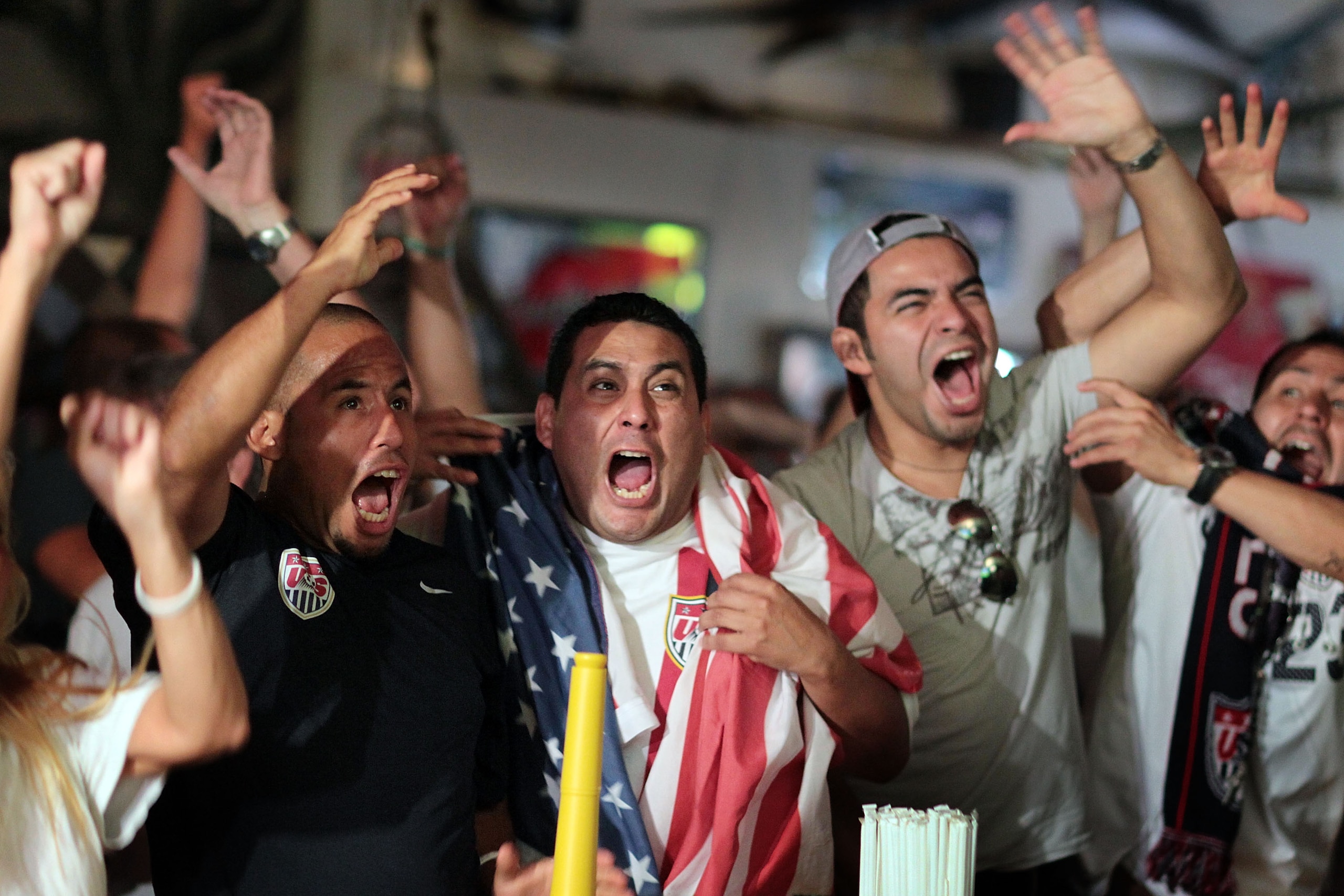 MIAMI - JUNE 23: Freddy Hurtado (L) and Wilfredo Hurtado (C) and others celebrate the winning goal for the USA soccer team while watching the 2010 FIFA World Cup South Africa Group C match between USA and Algeria on television at Churchill's pub on June MIAMI - JUNE 23: Freddy Hurtado (L) and Wilfredo Hurtado (C) and others celebrate the winning goal for the USA soccer team while watching the 2010 FIFA World Cup South Africa Group C match between USA and Algeria on television at Churchill's pub on June