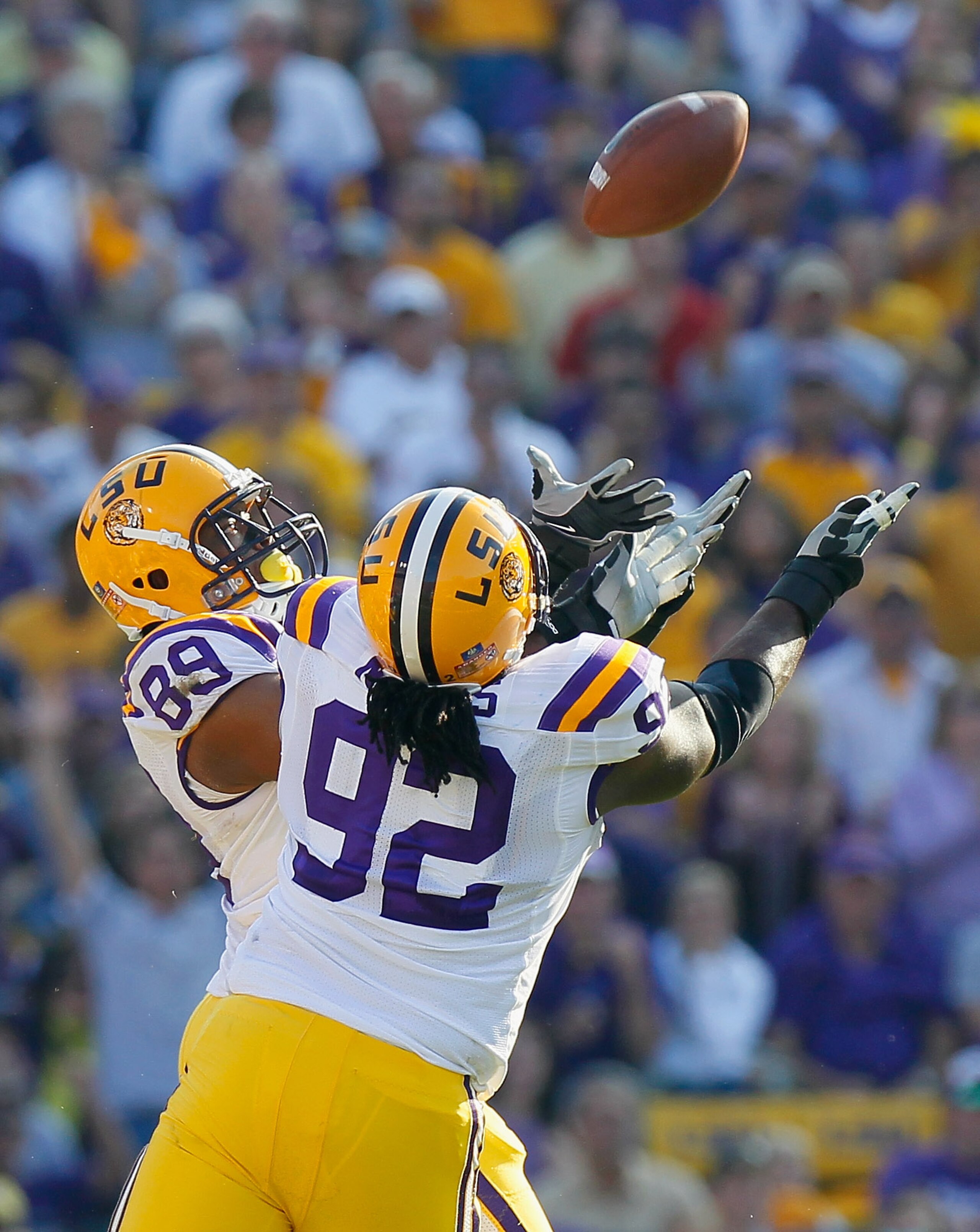 BATON ROUGE, LA - NOVEMBER 20:  Lavar Edward #89 and Drake Nevis #92 of the Louisiana State University Tigers intercept a pass broken up against the Ole Miss Rebels at Tiger Stadium on November 20, 2010 in Baton Rouge, Louisiana.  (Photo by Kevin C. Cox/G