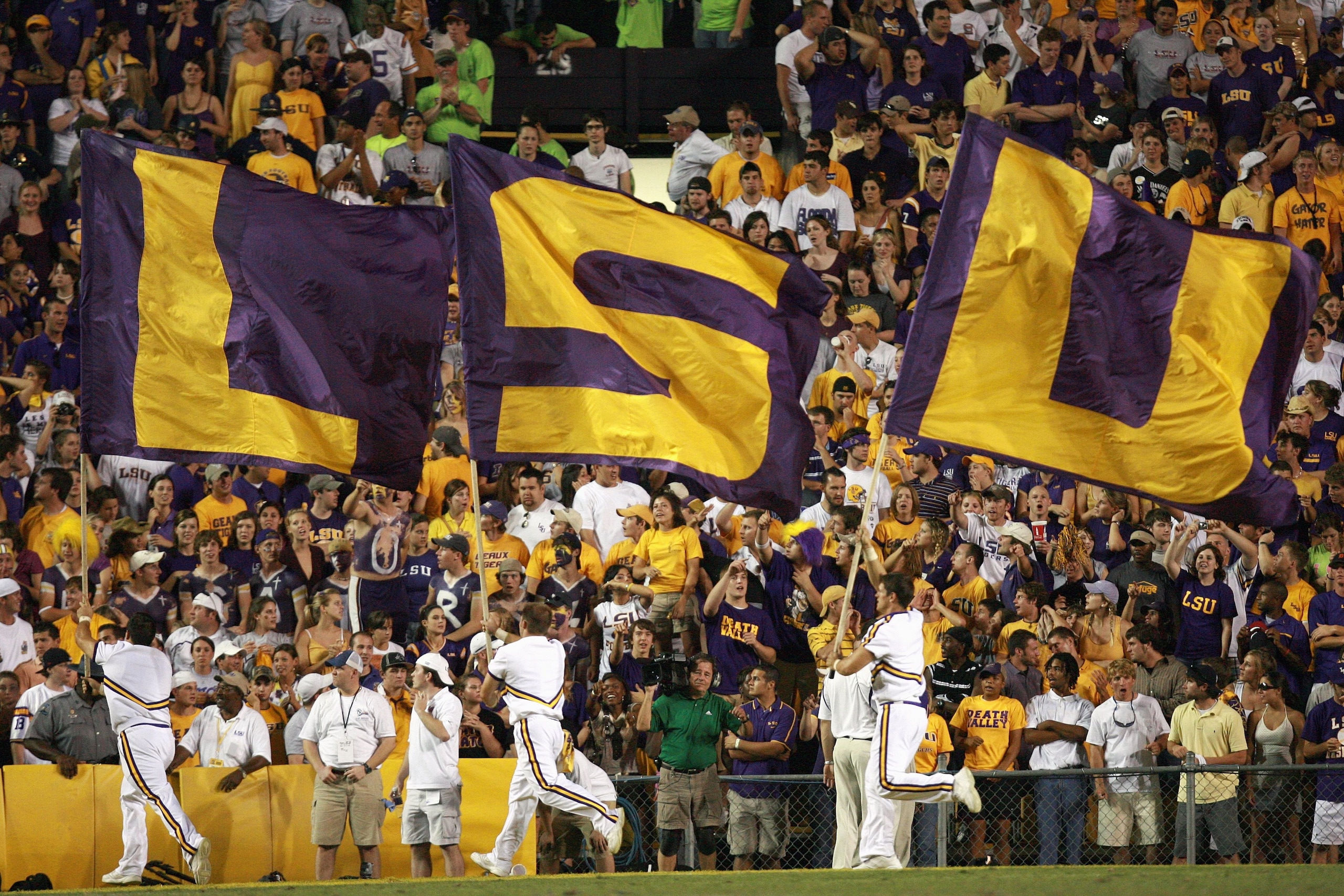 BATON ROUGE, LA - OCTOBER 06: Cheerleaders of the LSU Tigers carries flags against the Florida Gators at Tiger Stadium on October 6 , 2007 in Baton Rouge, Louisiana. LSU defeated Florida 28-24. (Photo by Doug Benc/Getty Images)