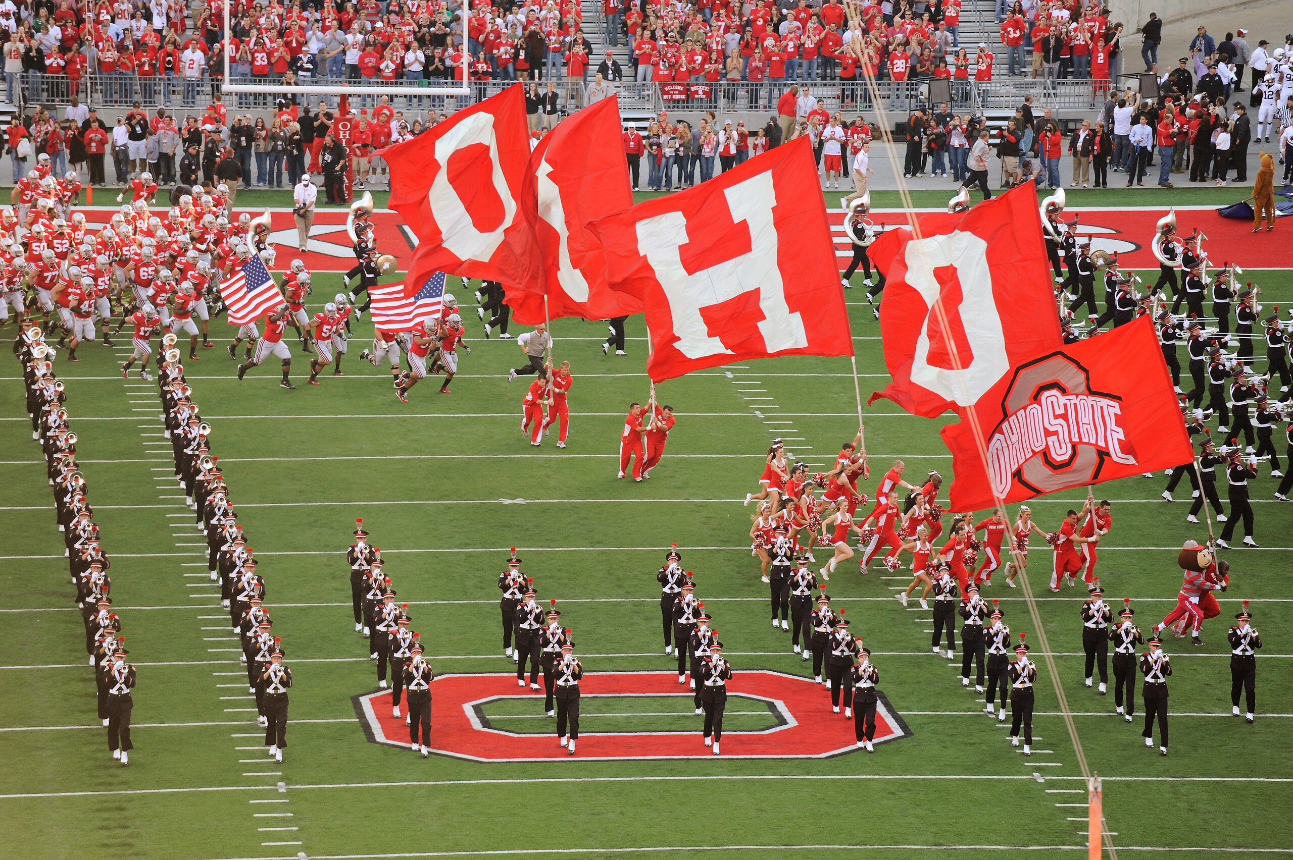 COLUMBUS, OH - NOVEMBER 13:  Bryant Browning #70 of the Ohio State Buckeyes and Cameron Heyward #97 of the Ohio State Buckeyes carry American flags to lead the Buckeyes on to the field before a game against the Penn State Nittany Lions at Ohio Stadium on