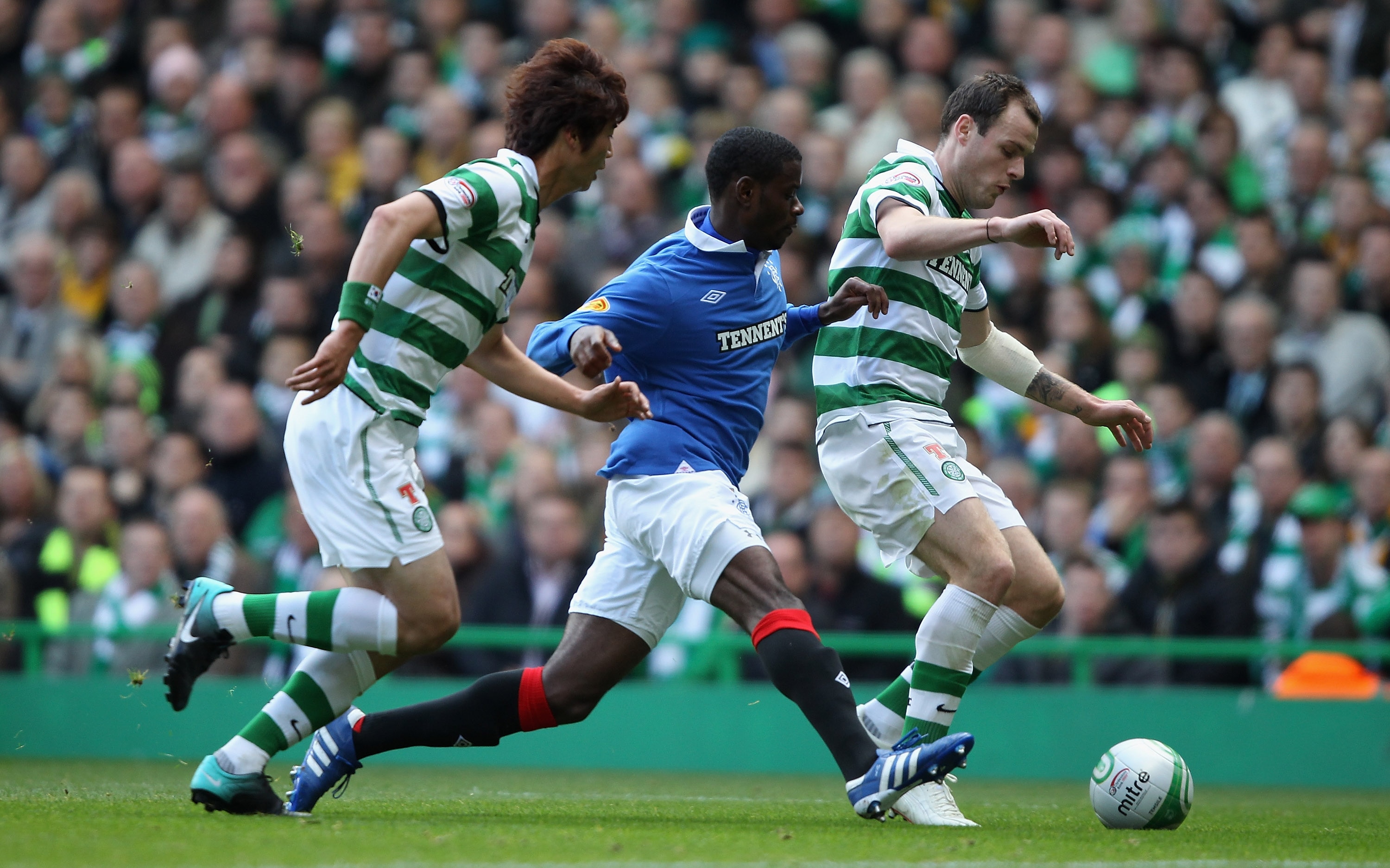 GLASGOW, SCOTLAND - OCTOBER 24:  Anthony Stokes of Celtic attempts to move away from Maurice Edu of Rangers during the Clydesdale Bank Premier League match between Celtic and Rangers at Celtic Park on October 24, 2010 in Glasgow, Scotland.  (Photo by Cliv