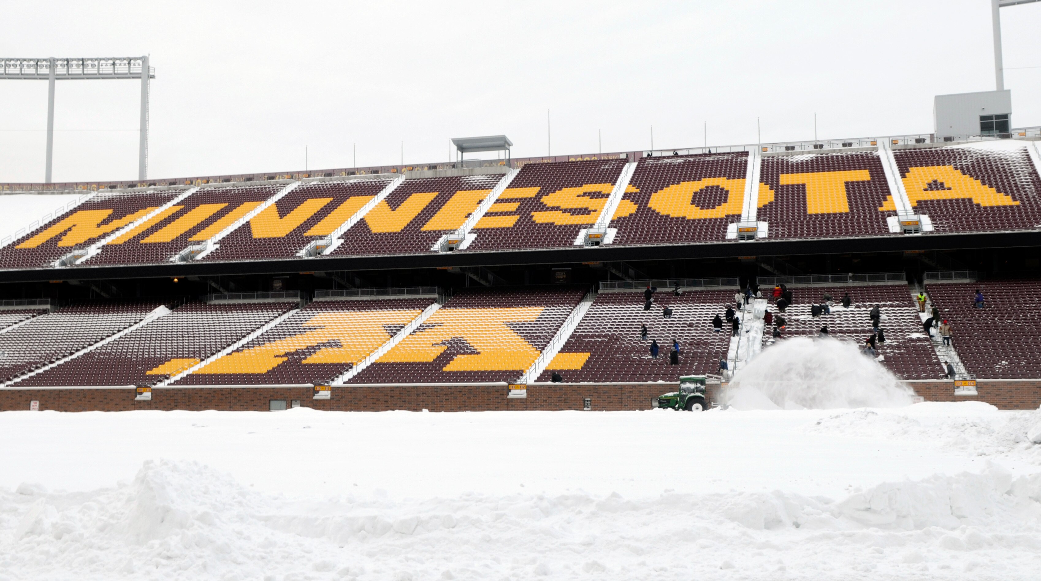MINNEAPOLIS, MN - DECEMBER 15: Workers shovel snow from the stands as TCF Bank Stadium prepares for a potential monday night football game between the Minnesota Vikings and Chicago Bears on December 15, 2010 in Minneapolis, Minnesota. Preparations are due