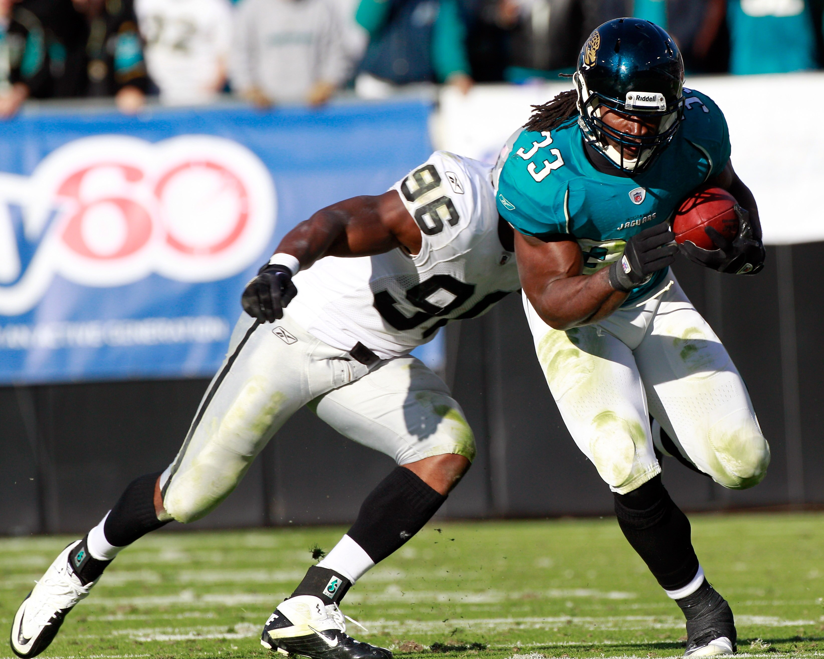 JACKSONVILLE, FL - DECEMBER 12:  Kamerion Wimbley #96 of the Oakland Raiders attempts to tackle Greg Jones #33 of the Jacksonville Jaguars runs during the game at EverBank Field on December 12, 2010 in Jacksonville, Florida.  (Photo by Sam Greenwood/Getty