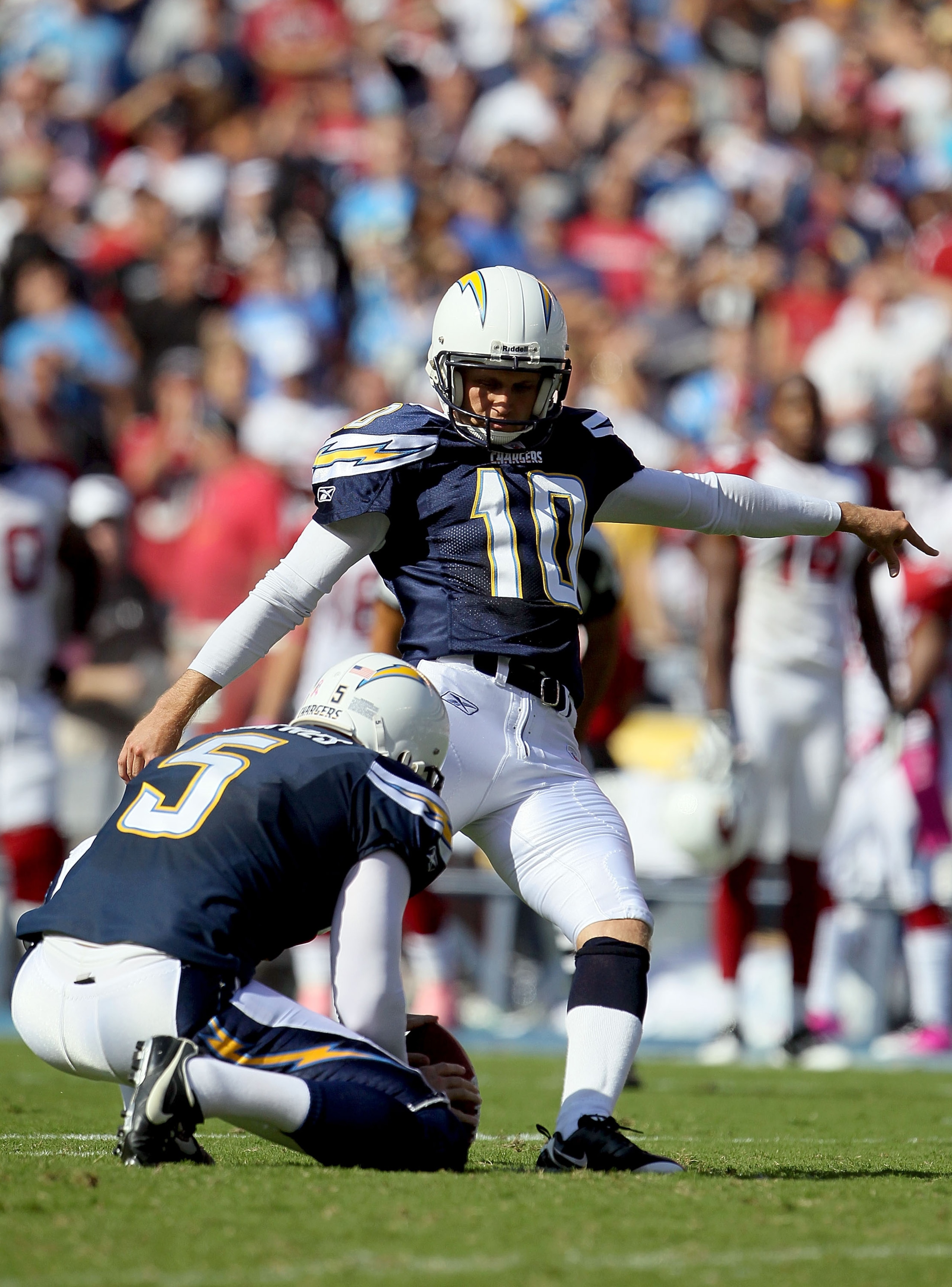 SAN DIEGO - OCTOBER 03:  Nate Kaeding #10 of the San Diego Chargers kicks the ball from Mike Scifres #5 during the game against the Arizona Cardinals at Qualcomm Stadium on October 3, 2010 in San Diego, California.  (Photo by Jeff Gross/Getty Images)