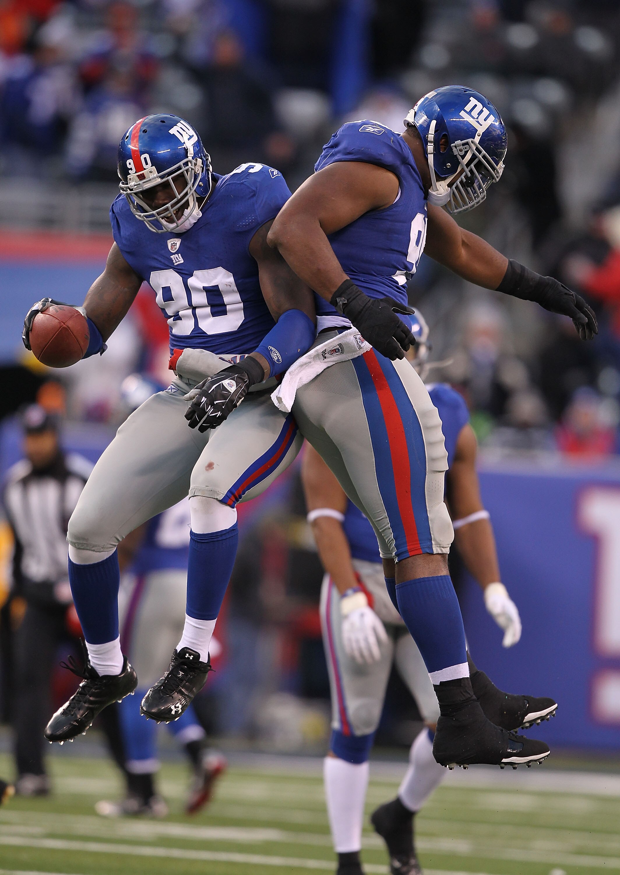 EAST RUTHERFORD, NJ - DECEMBER 05:  Jason Pierre-Paul #90 of the New York Giants celebrates running with Justin Tuck after running back a fumble by the Washington Redskins during their game on December 5, 2010 at The New Meadowlands Stadium in East Ruther