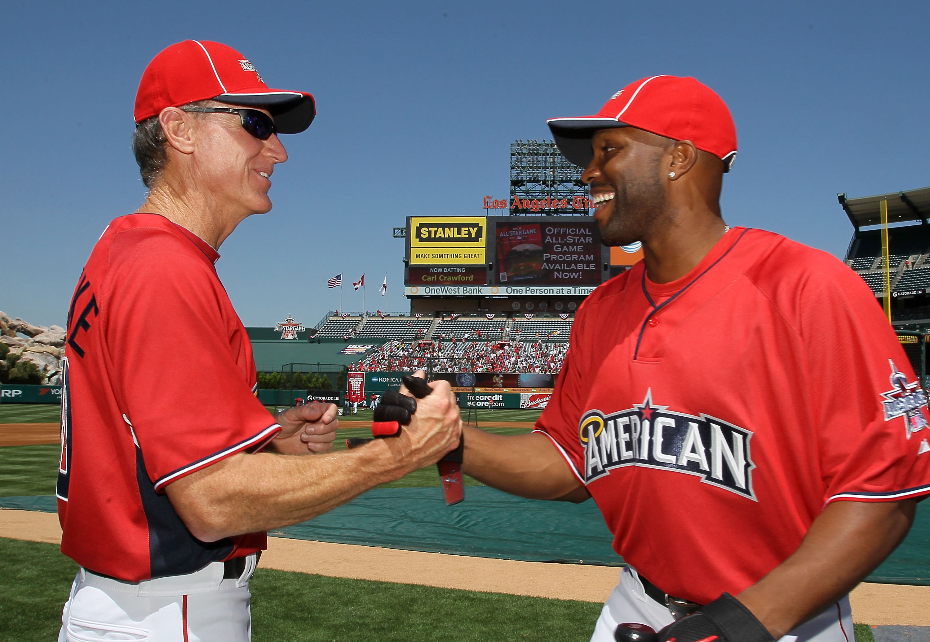 ANAHEIM, CA - JULY 12:  Los Angeles Angels of Anaheim bench coach Ron Roenicke and American League All-Star Torii Hunter #48 of the Angels shake hands during Gatorade All-Star Workout Day at Angel Stadium of Anaheim on July 12, 2010 in Anaheim, California