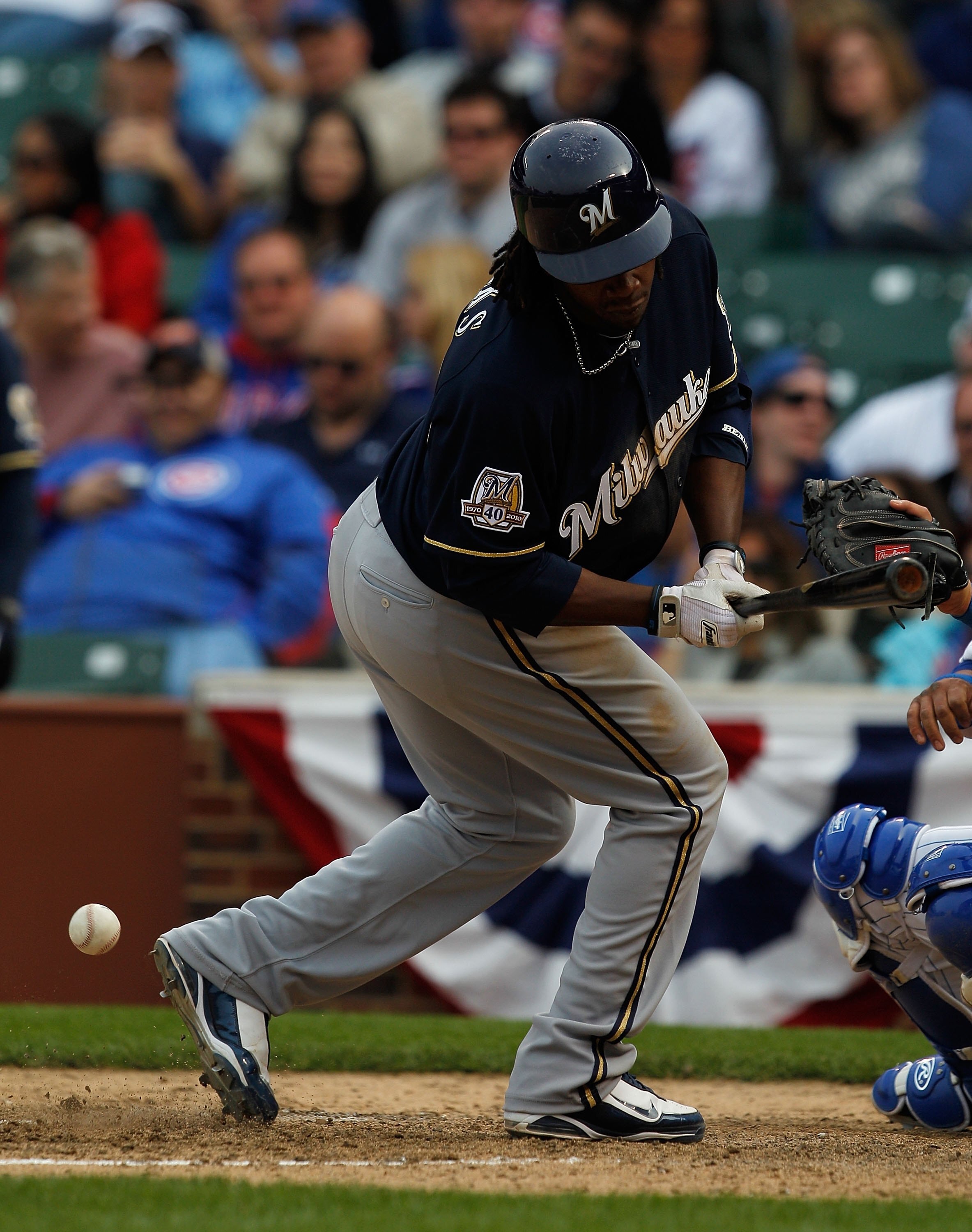 CHICAGO - APRIL 12: Rickeie Weeks #21 of the Milwaukee Brewers recoils after being hit by a pitch in the 9th inning against the Chicago Cubs on Opening Day at Wrigley Field on April 12, 2010 in Chicago, Illinois. The Cubs defeated the Brewers 9-5. (Photo