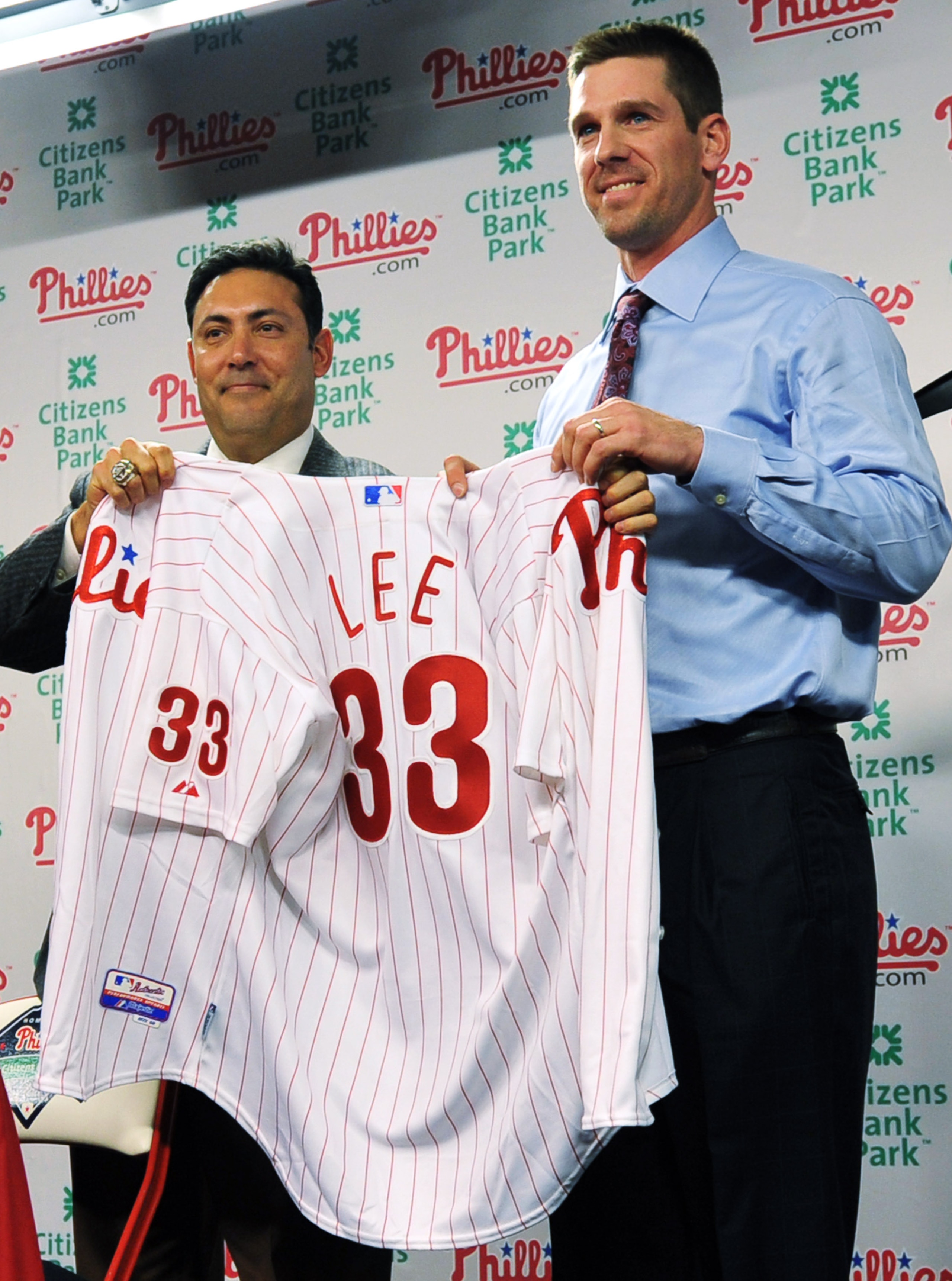 PHILADELPHIA - DECEMBER 15: Pitcher Cliff Lee (R) #33 of the Philadelphia Phillies is introduced to the media and presented his jersey by the Philadelphia Phillies general manager Ruben Amaro Jr. during a press conference at Citizens Bank Park on Decembe PHILADELPHIA - DECEMBER 15: Pitcher Cliff Lee (R) #33 of the Philadelphia Phillies is introduced to the media and presented his jersey by the Philadelphia Phillies general manager Ruben Amaro Jr. during a press conference at Citizens Bank Park on Decembe