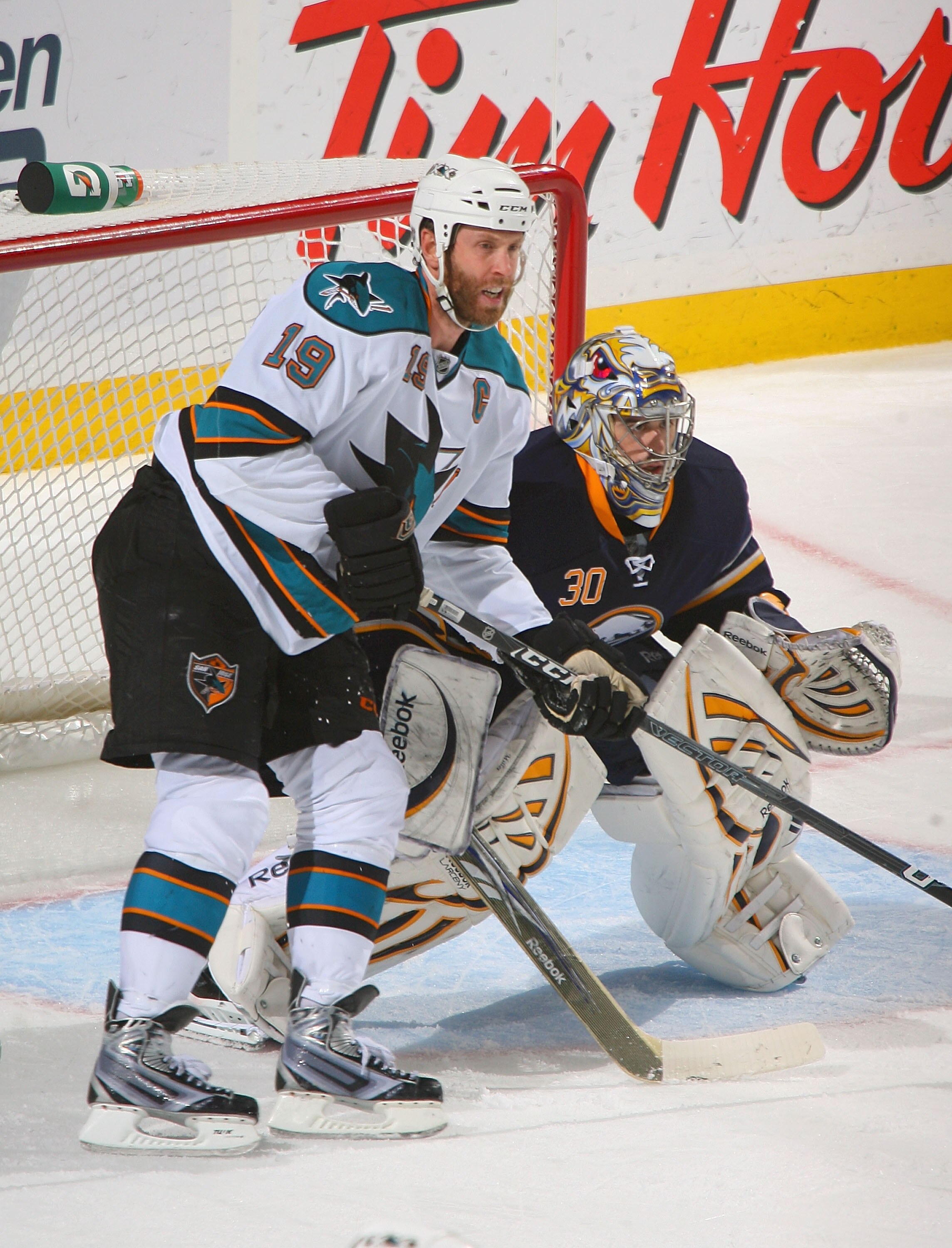 BUFFALO, NY - DECEMBER 09:  Joe Thornton #19 of the San Jose Sharks looks to make a play against Ryan Miller #30 of the Buffalo Sabres  at HSBC Arena on December 9, 2010 in Buffalo, New York. Buffalo won 6-3.  (Photo by Rick Stewart/Getty Images)
