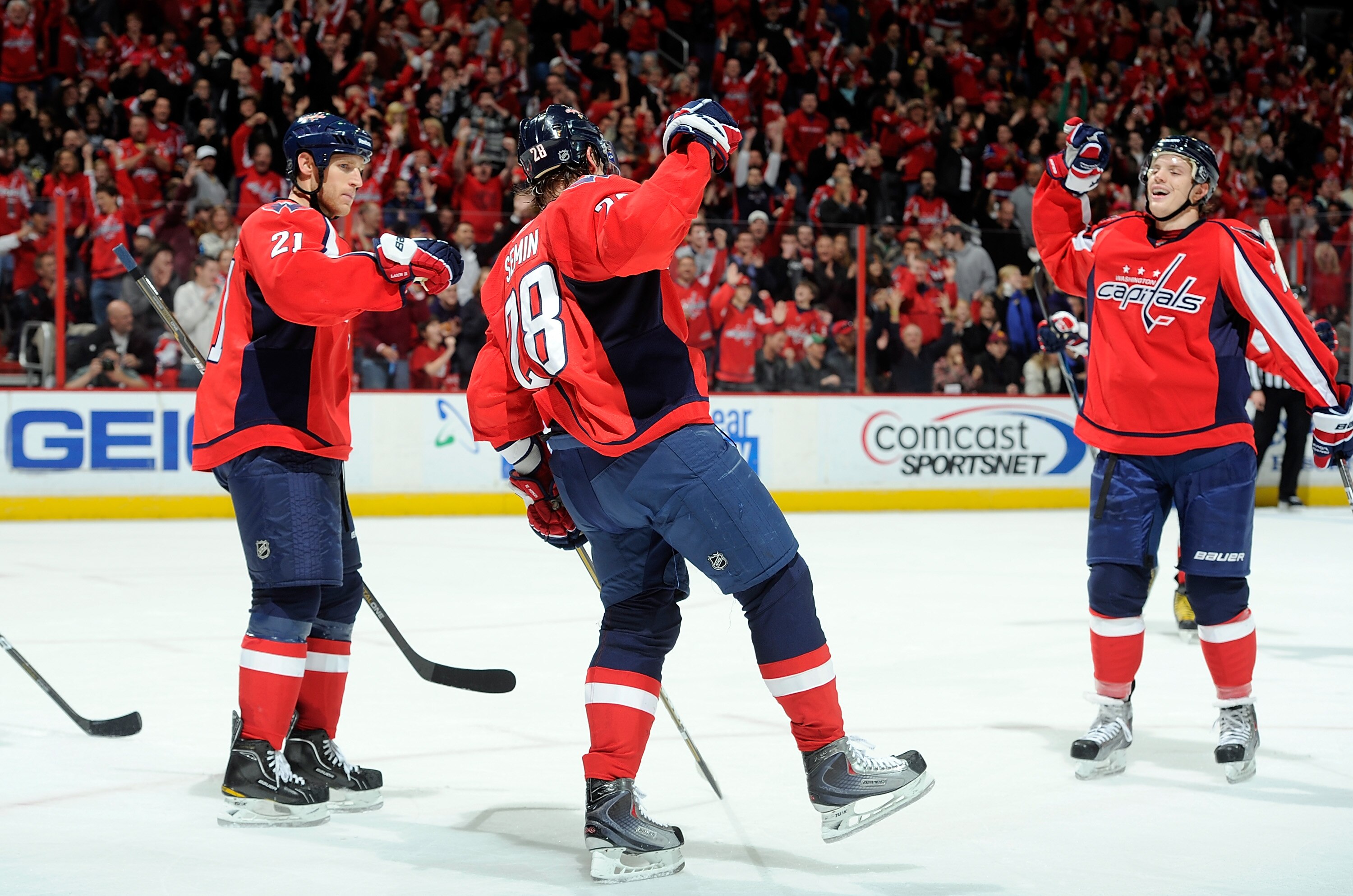 WASHINGTON - NOVEMBER 26:  Alexander Semin #8 of the Washington Capitals celebrates with Brooks Laich #21 and John Carlson #74 after scoring a hat trick in the second period against the Tampa Bay Lightning  at the Verizon Center on November 26, 2010 in Wa