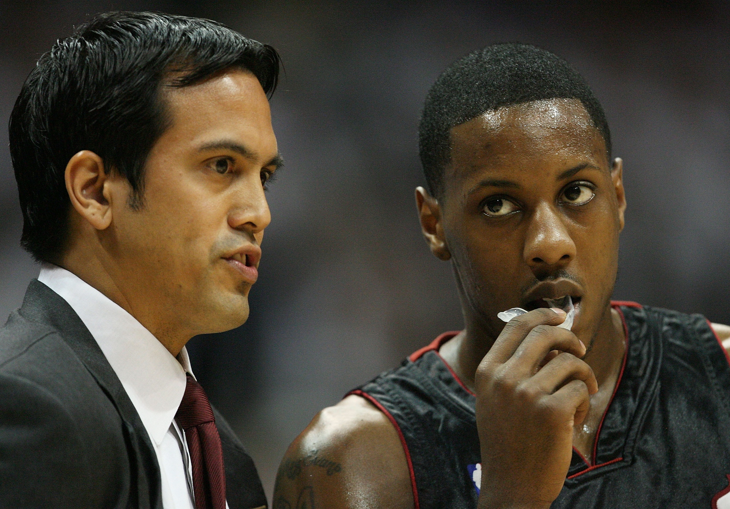 ATLANTA - APRIL 29:  Head coach Erik Spoelstra talks with Mario Chalmers #6 of the Miami Heat while taking on the Atlanta Hawks during Game Five of the Eastern Conference Quarterfinals at Philips Arena on April 29, 2009 in Atlanta, Georgia. NOTE TO USER: