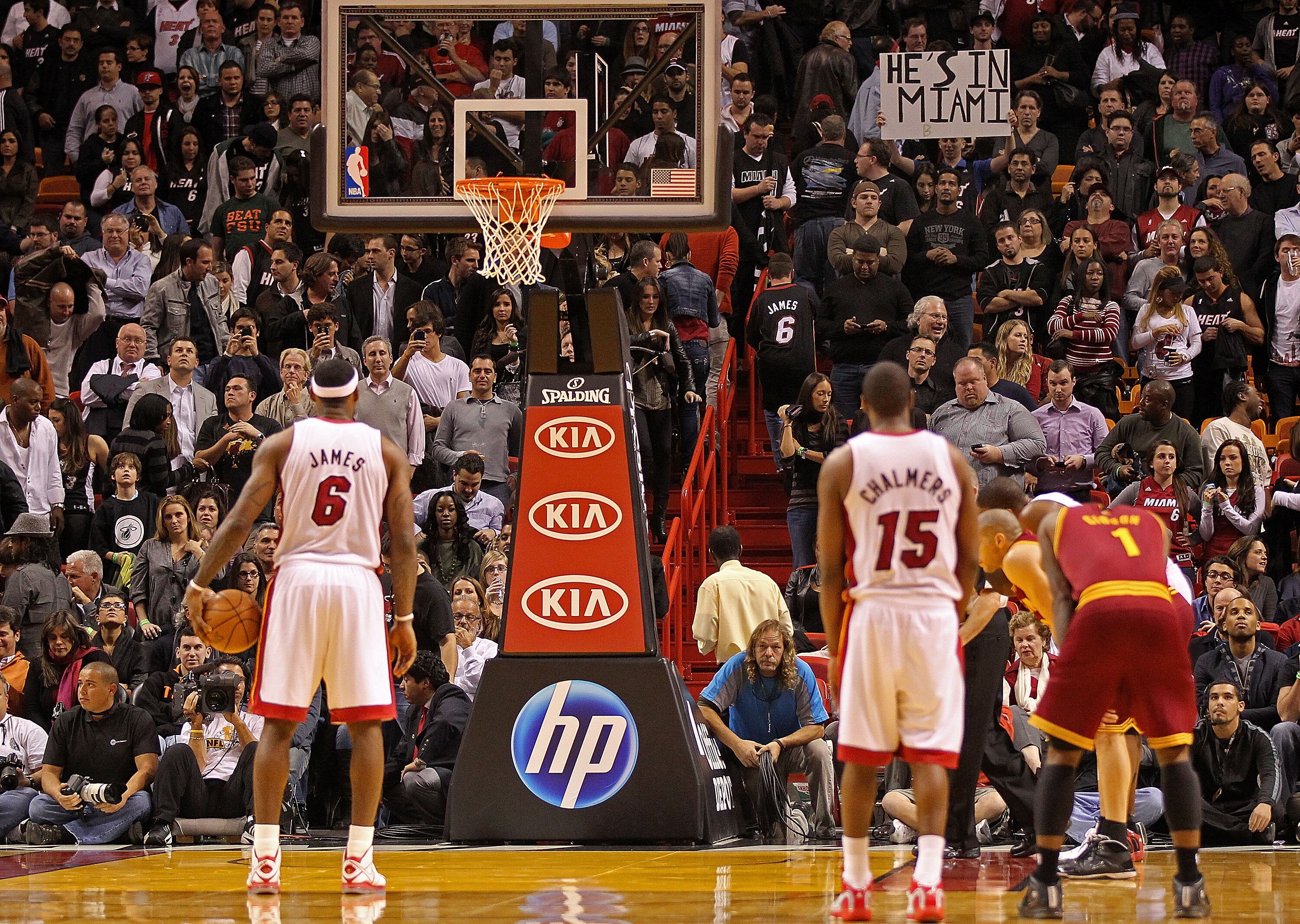 MIAMI, FL - DECEMBER 15:  LeBron James #6 of the Miami Heat shoots a foul shot as a fan holds a sign saying 'He's in Miami' during a game against the Cleveland Cavaliers at American Airlines Arena on December 15, 2010 in Miami, Florida. NOTE TO USER: User
