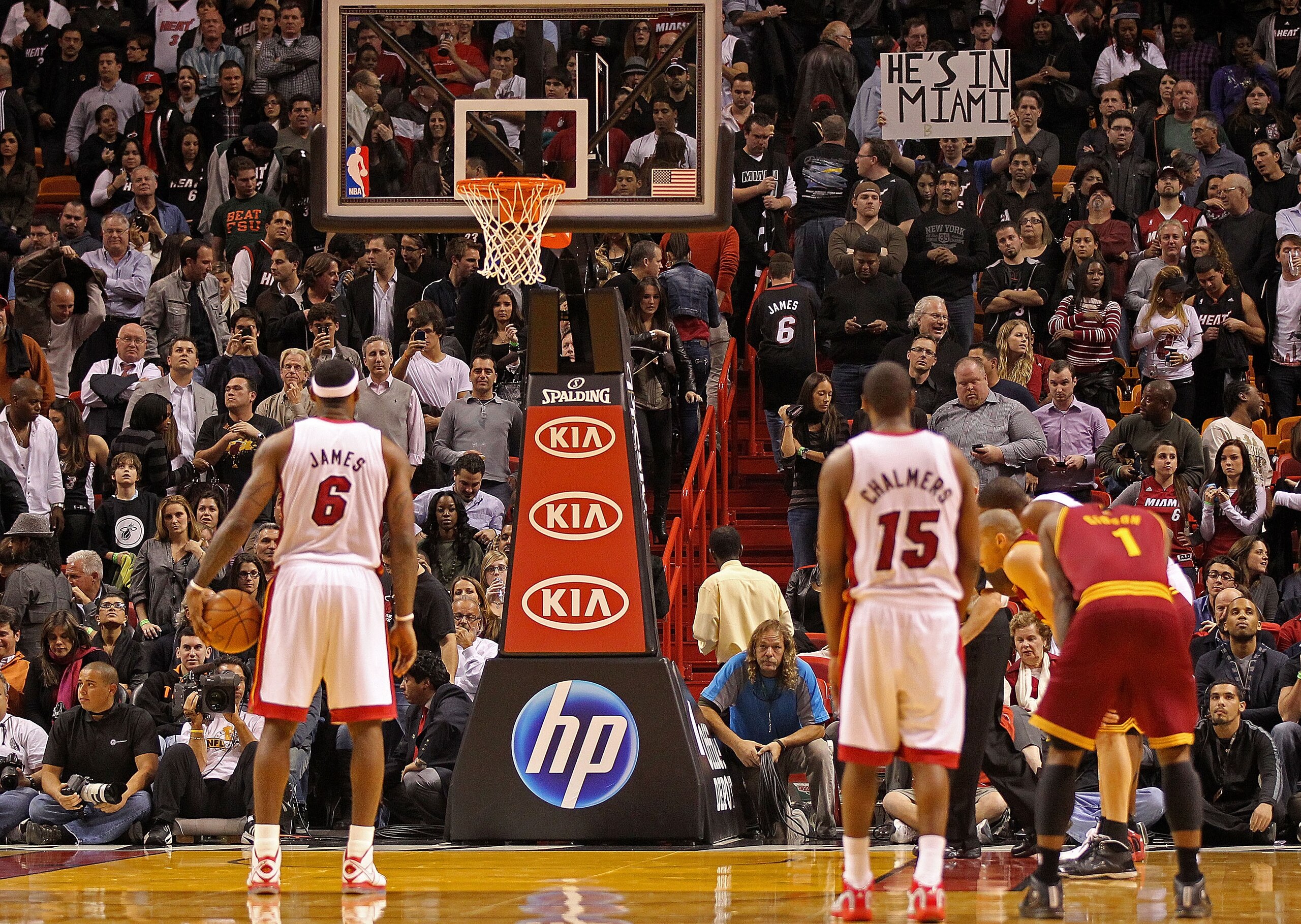 MIAMI, FL - DECEMBER 15:  LeBron James #6 of the Miami Heat shoots a foul shot as a fan holds a sign saying 'He's in Miami' during a game against the Cleveland Cavaliers at American Airlines Arena on December 15, 2010 in Miami, Florida. NOTE TO USER: User