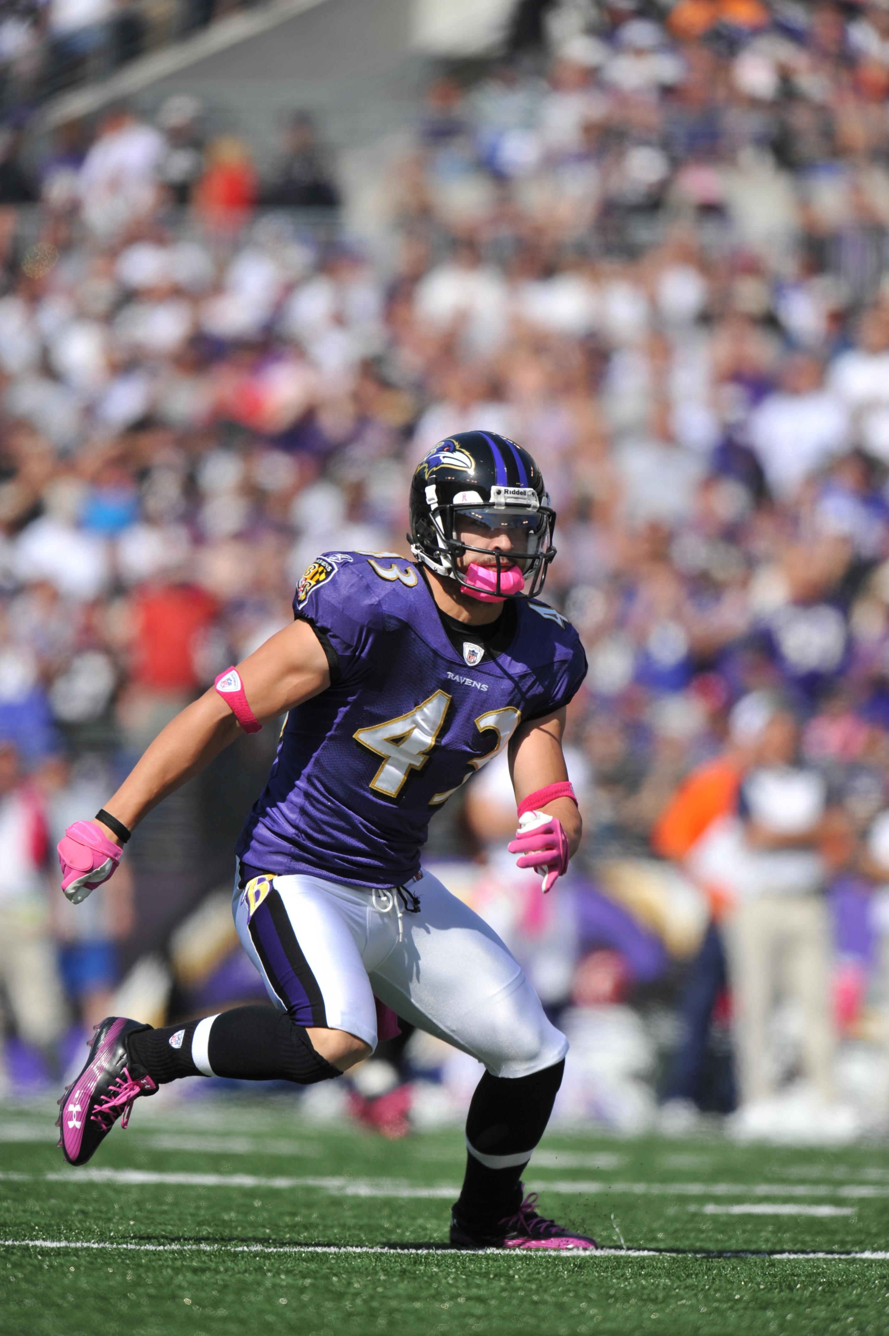 BALTIMORE, MD - OCTOBER 10: Haruki Nakamura #43 of the Baltimore Ravens defends against the Denver Broncos at M&T Bank Stadium on October 10, 2010 in Baltimore, Maryland. Players wore pink in recognition of Breast Cancer Awareness Month. The Ravens defeat