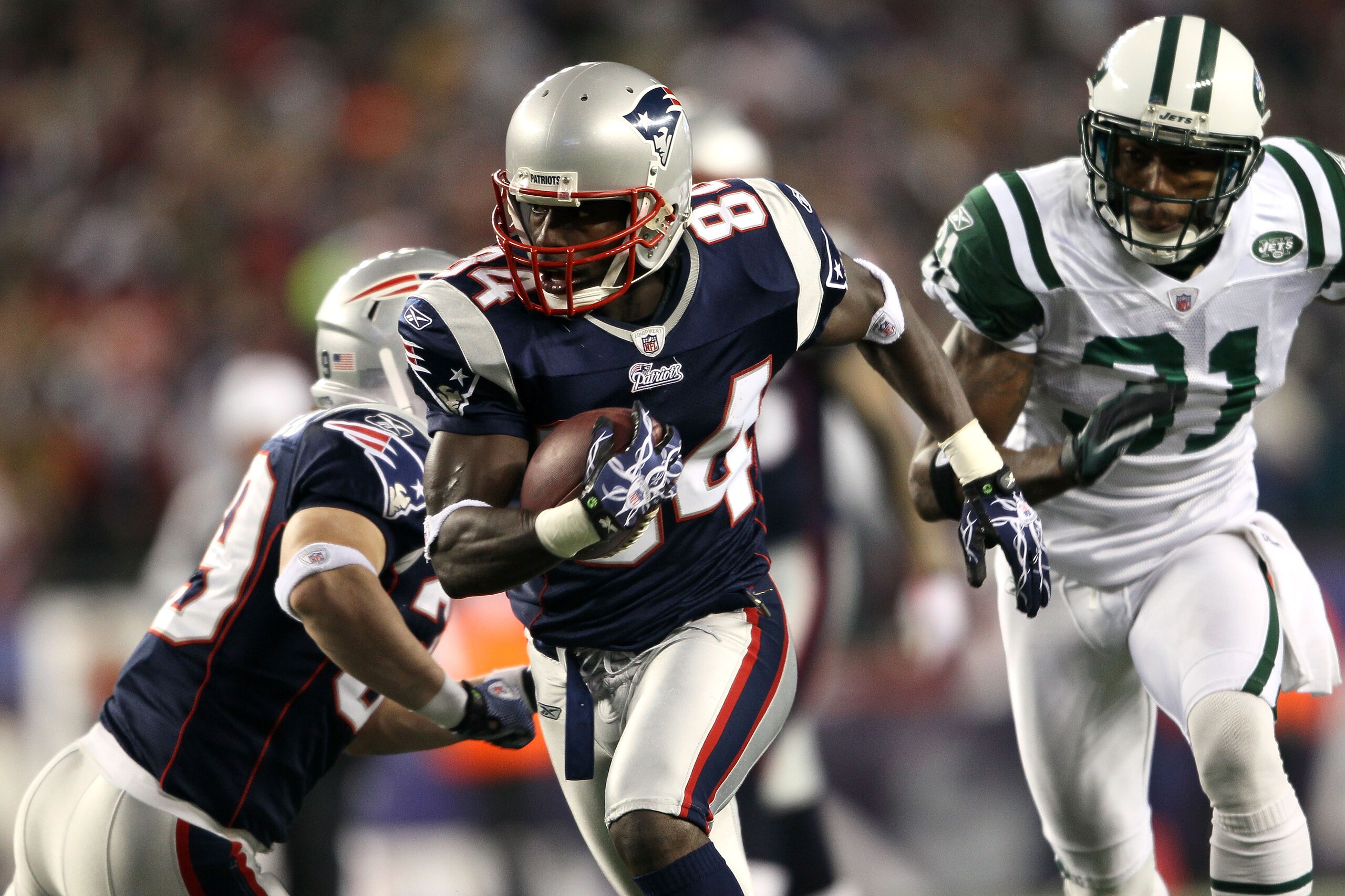 FOXBORO, MA - DECEMBER 06:  Deion Branch #84 of the New England Patriots scores on a 25-yard touchdown reception in the first quarter against Antonio Cromartie #31 of the New York Jets at Gillette Stadium on December 6, 2010 in Foxboro, Massachusetts.  (P