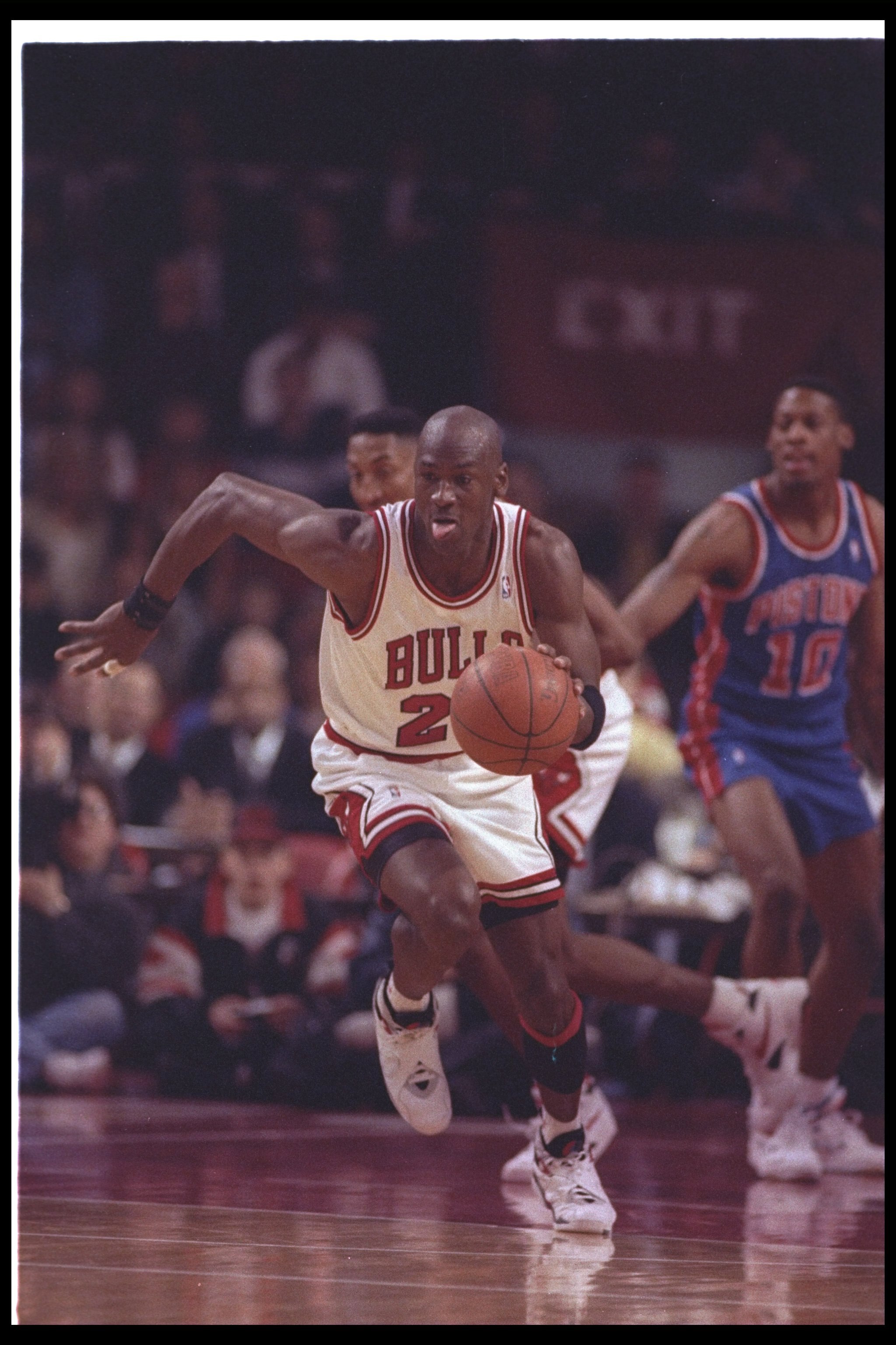 22 Apr 1993:  Guard Michael Jordan #23 of the Chicago Bulls  dribbles the ball hard up the court on a fast break during a game against the Detroit Pistons at the United Center in Chicago, Illinois.  Dennis Rodman from the Detroit Pistons is watching in th