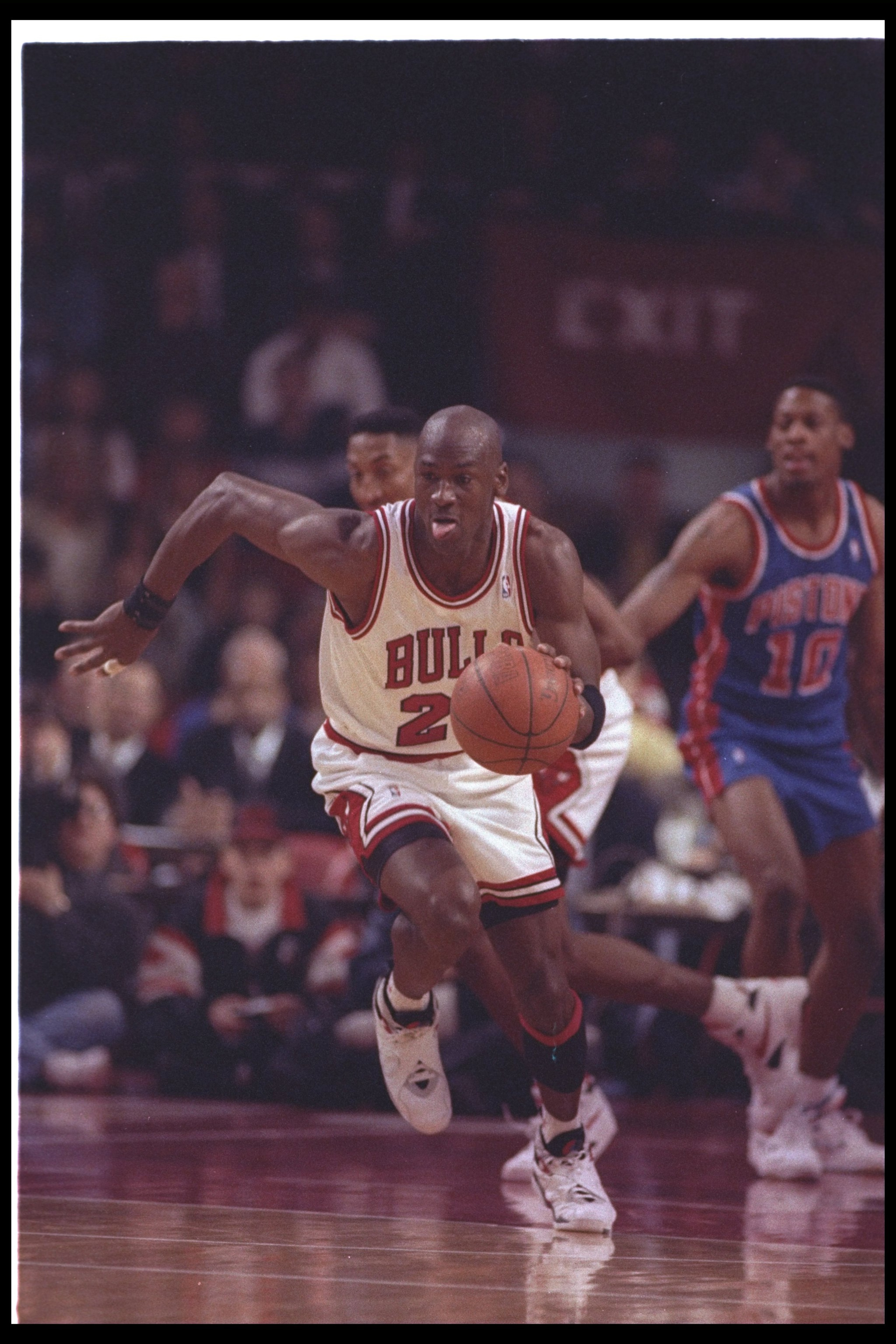 22 Apr 1993:  Guard Michael Jordan #23 of the Chicago Bulls  dribbles the ball hard up the court on a fast break during a game against the Detroit Pistons at the United Center in Chicago, Illinois.  Dennis Rodman from the Detroit Pistons is watching in th