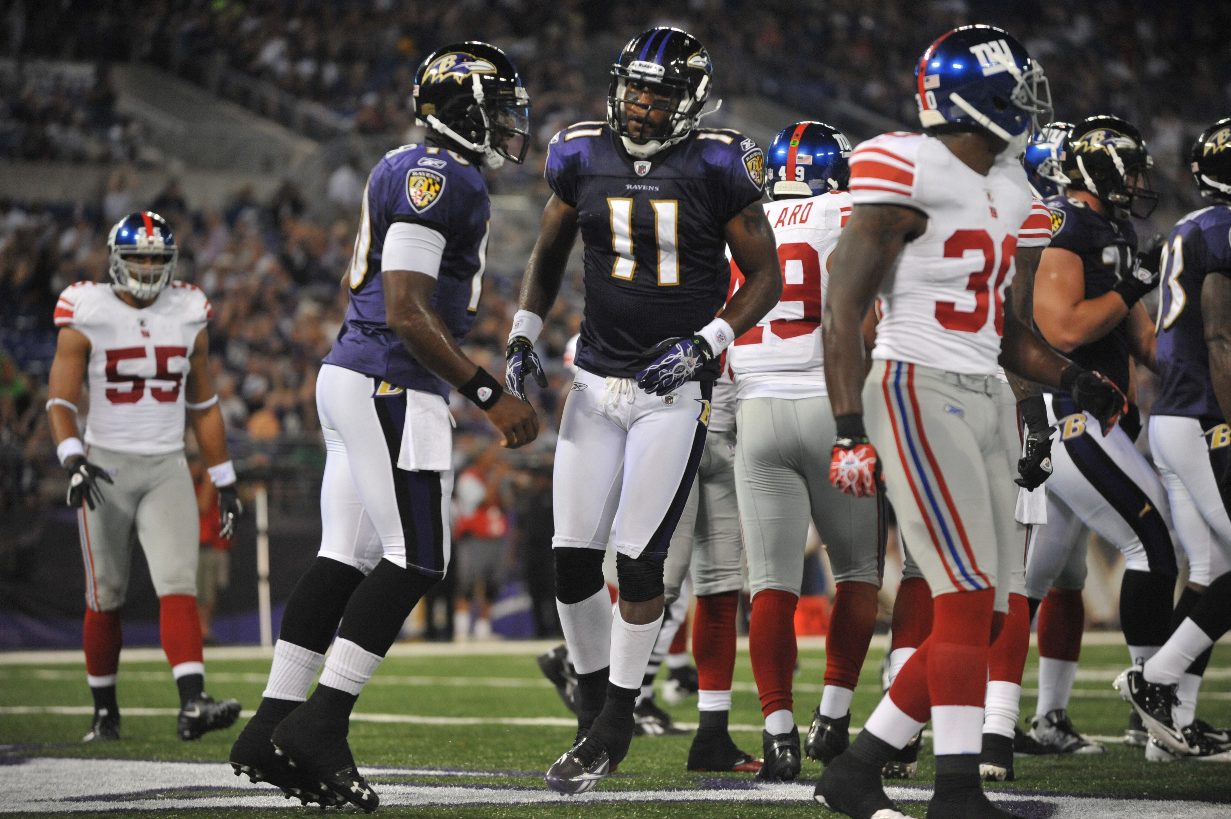 BALTIMORE - AUGUST 28:  Marcus Smith #11 of the Baltimore Ravens celebrates his touchdown against the New York Giants in a preseason game at M&T Bank Stadium on August 28, 2010 in Baltimore, Maryland. The Ravens defeated the Giants 24-10. (Photo by Larry