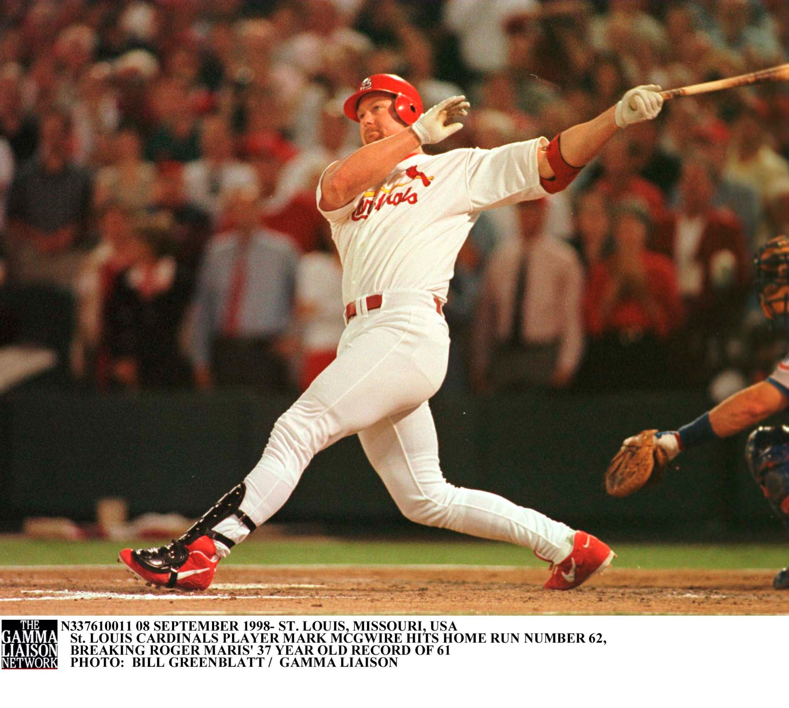 SLP98090812- 08 SEPTEMBER 1998- ST. LOUIS, MISSOURI, USA: St. Louis Cardinals'' Mark McGwire takes a big swing as he watches history being made, with his 341-foot-62nd home run of the season in the fourth inning, September 8. McGwire now surpasses the 37-