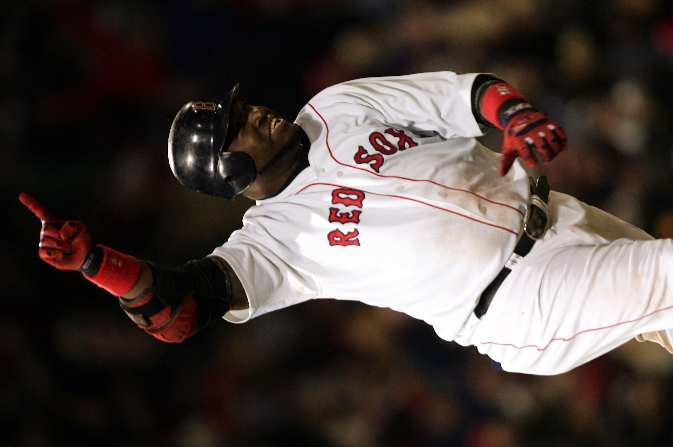 BOSTON - OCTOBER 18:  David Ortiz #34 of the Boston Red Sox celebrates after hitting the game winning RBI single in the fourteenth inning to defeat the New York Yankees 5-4 during game five of the American League Championship Series on October 18, 2004 at