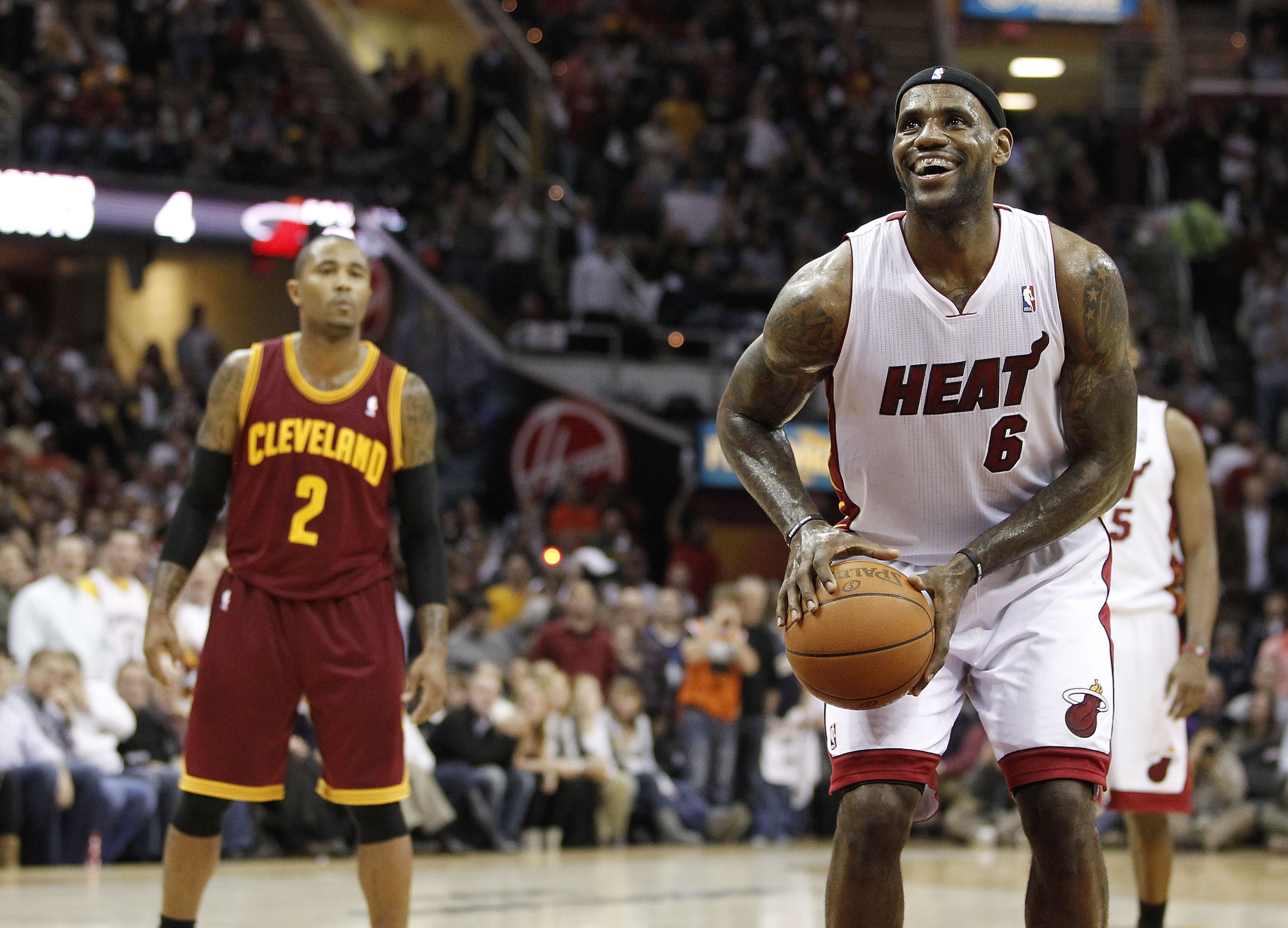 CLEVELAND, OH - DECEMBER 02: LeBron James #6 of the Miami Heat smiles while takeing a free throw in front of Mo Williams #2 of the Cleveland Cavaliers at Quicken Loans Arena on December 2, 2010 in Cleveland, Ohio. NOTE TO USER: User expressly acknowledge CLEVELAND, OH - DECEMBER 02: LeBron James #6 of the Miami Heat smiles while takeing a free throw in front of Mo Williams #2 of the Cleveland Cavaliers at Quicken Loans Arena on December 2, 2010 in Cleveland, Ohio. NOTE TO USER: User expressly acknowledge