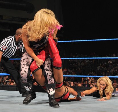 Natalya puts the sharpshooter on Layla and Michelle tries to help her partner, photo copyright to WWE.com