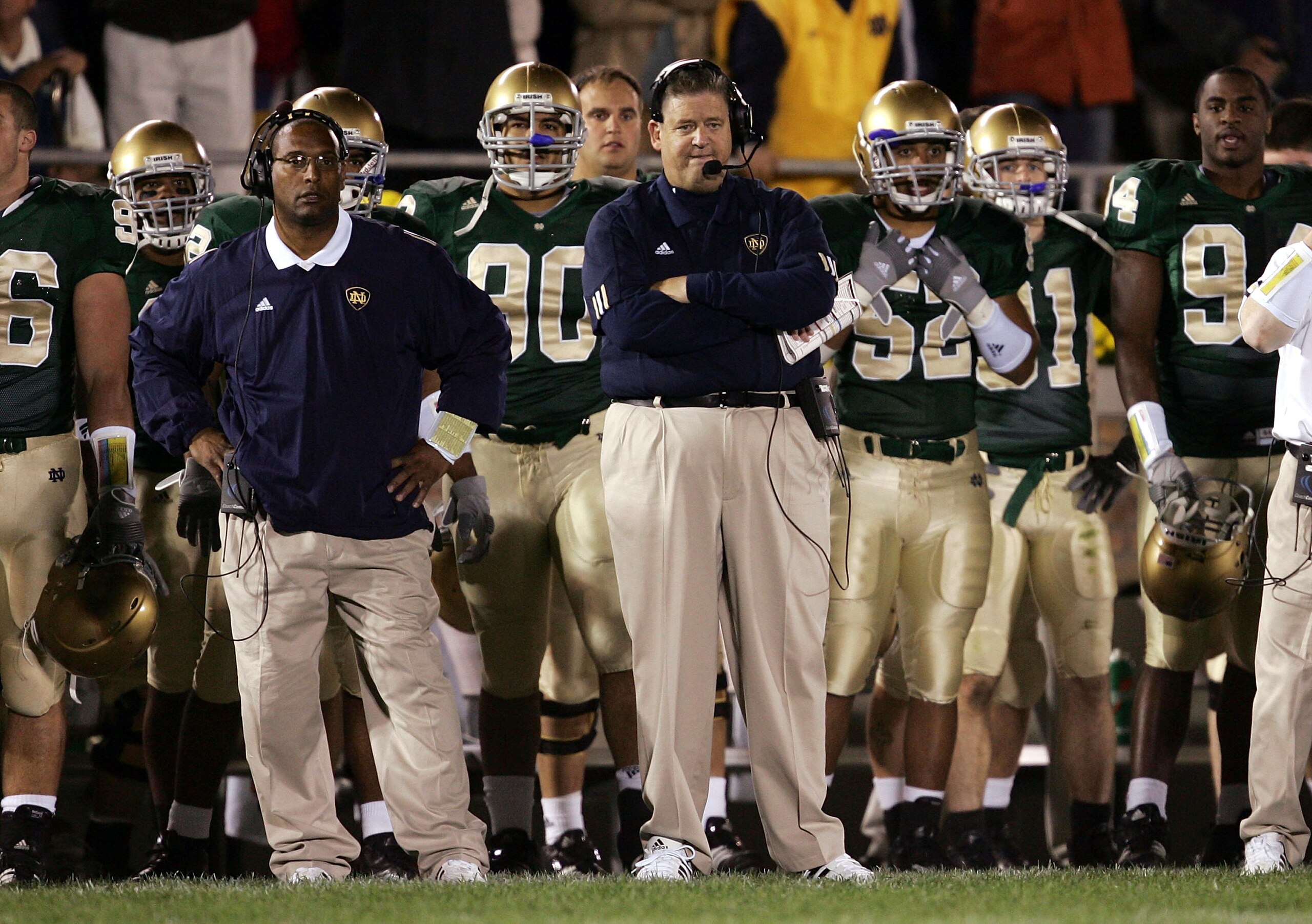SOUTH BEND, IN - OCTOBER 15:  Head coach Charlie Weis of the Notre Dame Fighting Irish (C) watches the end of a game against the University of Southern California Trojans with assistant Mike Haywood (L) on October 15, 2005 at Notre Dame Stadium in South B