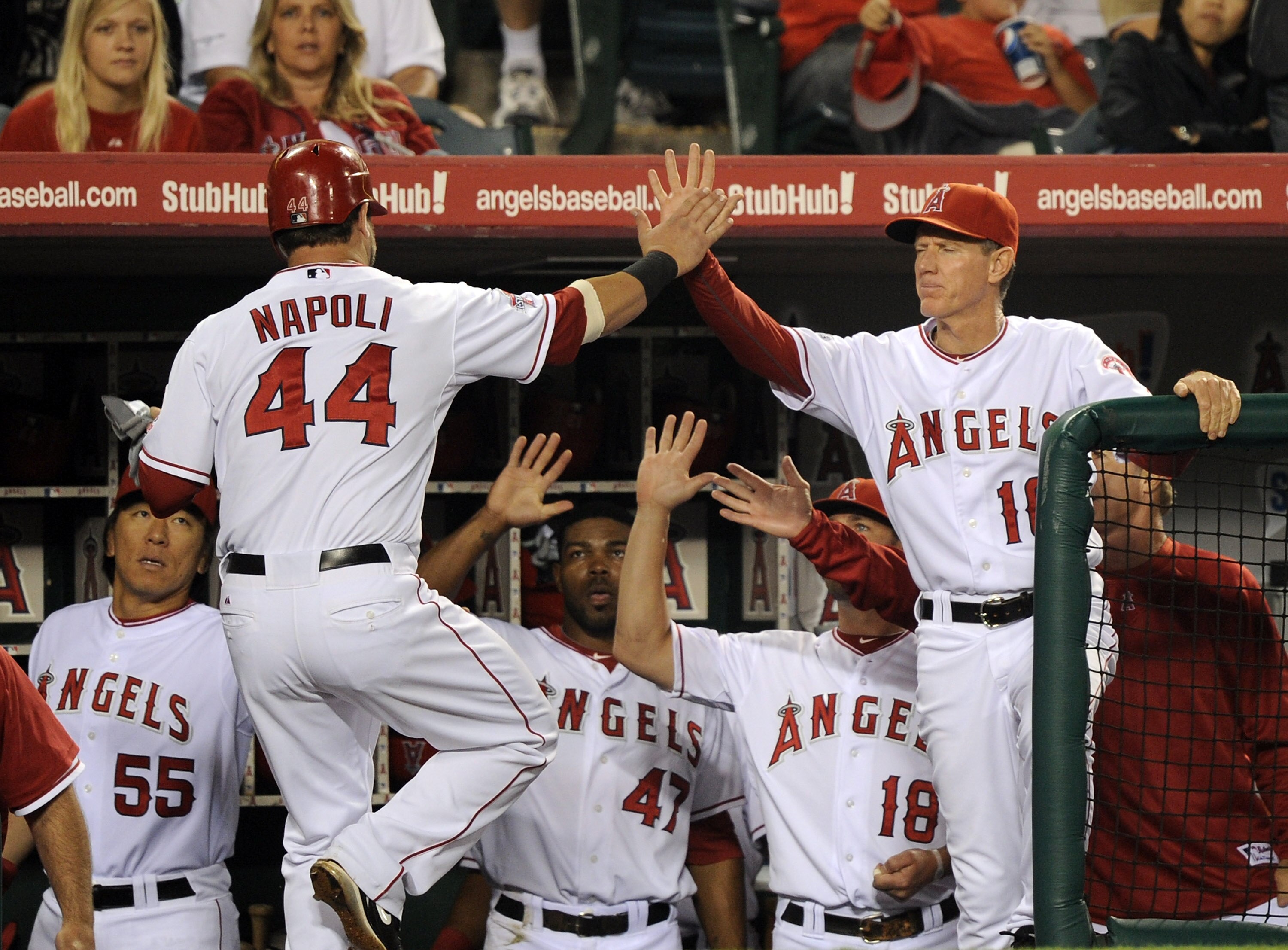ANAHEIM, CA - SEPTEMBER 20:  Mike Napoli #44 of the Los Angeles Angels of Anaheim celebrates his run with Ron Roenicke #10, Hideki Matsui #55, and Howie Kendrick #47 for a 1-0 lead over the Texas Rangers during the second inning at Angel Stadium on Septem