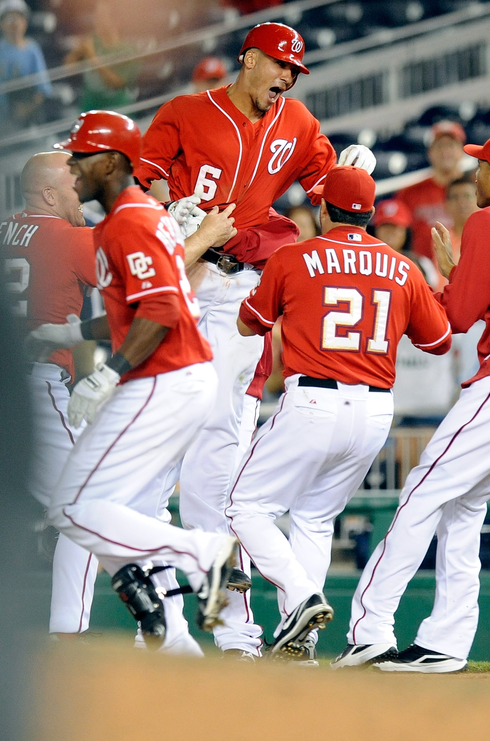 WASHINGTON - AUGUST 26:  Ian Desmond #6 of the Washington Nationals is mobbed by teammates after driving in the game winning run in the thirteenth inning against the St. Louis Cardinals at Nationals Park on August 26, 2010 in Washington, DC.  The National