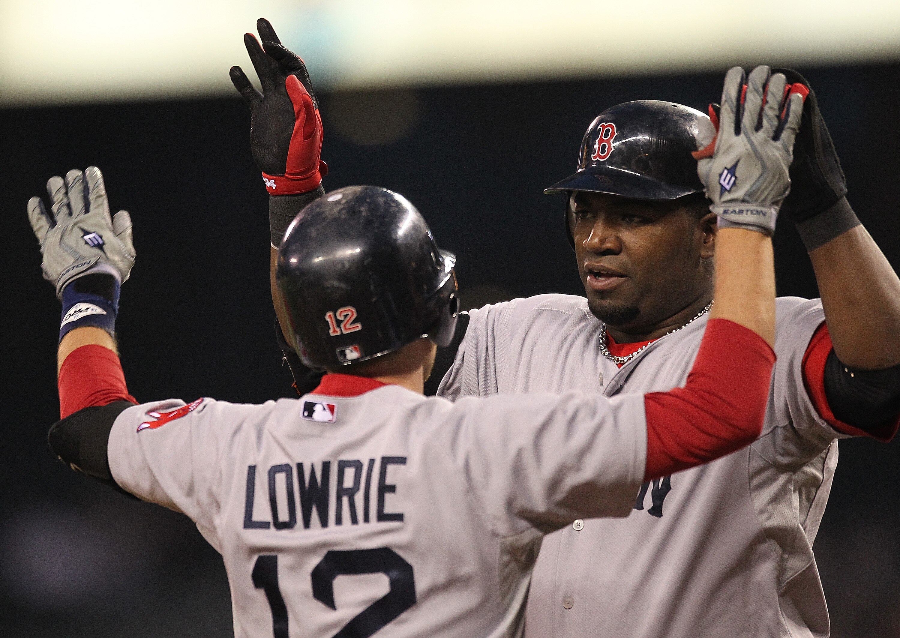 SEATTLE - SEPTEMBER 14:  Jed Lowrie #12 of the Boston Red Sox is congratulated by David Ortiz #34 after hitting a two-run home run against the Seattle Mariners at Safeco Field on September 14, 2010 in Seattle, Washington. (Photo by Otto Greule Jr/Getty Im