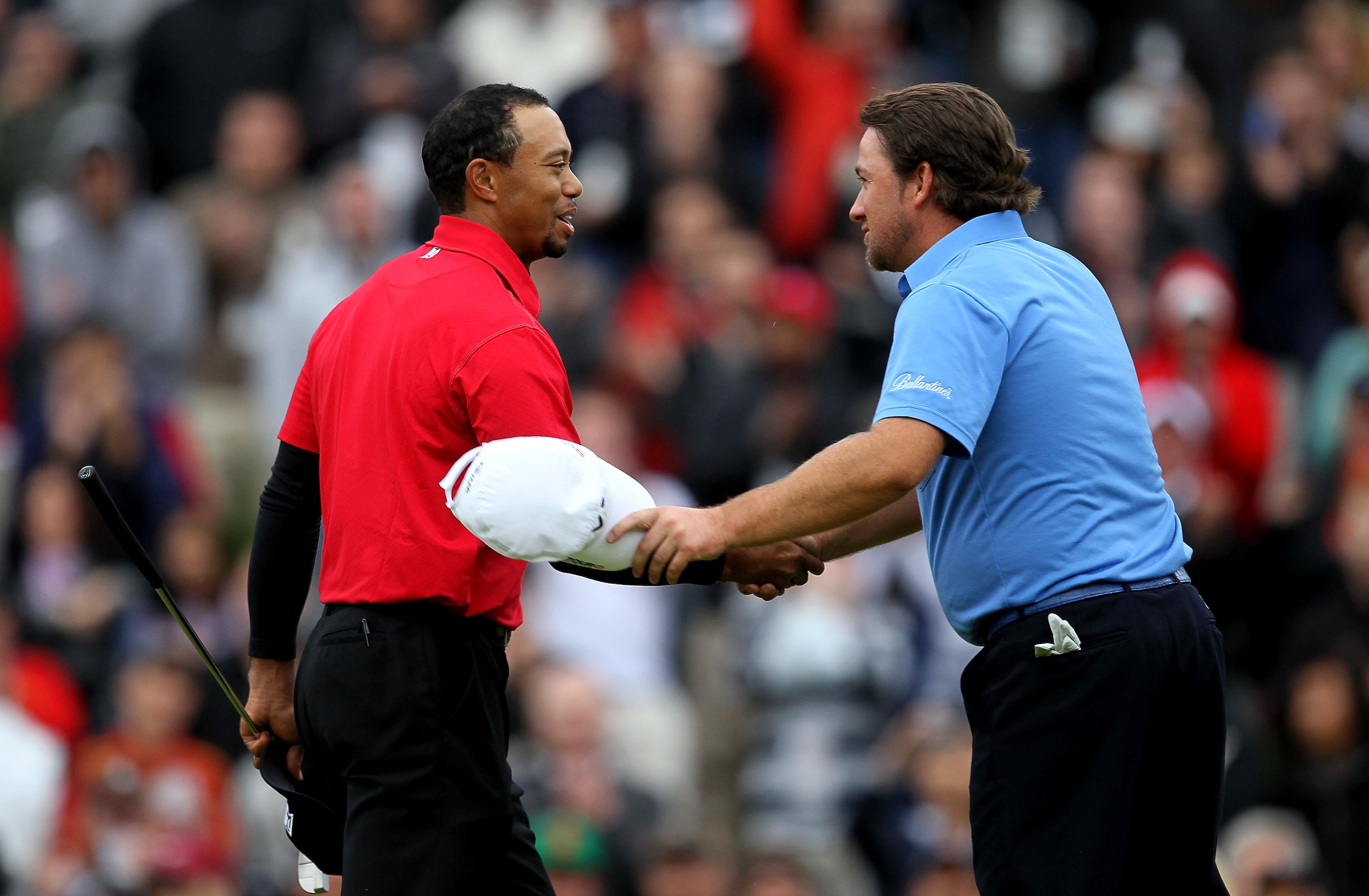 THOUSAND OAKS, CA - DECEMBER 05:  Graeme McDowell of Northern Ireland (R) and Tiger Woods shake hands on the 18th green after they finished regulation in a tie during the final round of the Chevron World Challenge at Sherwood Country Club on December 5, 2