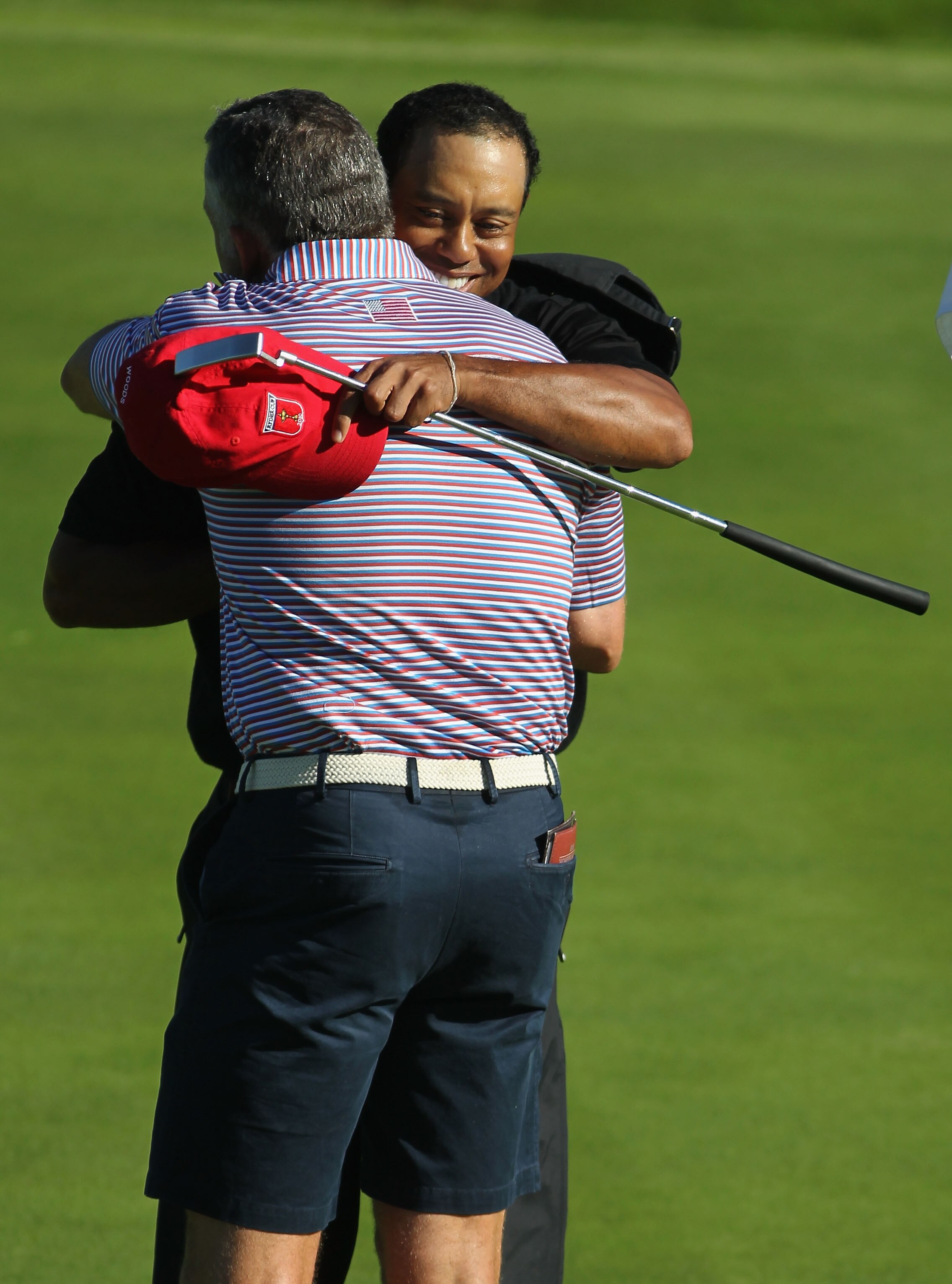 NEWPORT, WALES - OCTOBER 04:  Tiger Woods of the USA hugs his caddie Steve Williams on the 15th green after winning 4&3 in the singles matches during the 2010 Ryder Cup at the Celtic Manor Resort on October 4, 2010 in Newport, Wales.  (Photo by Jamie Squi