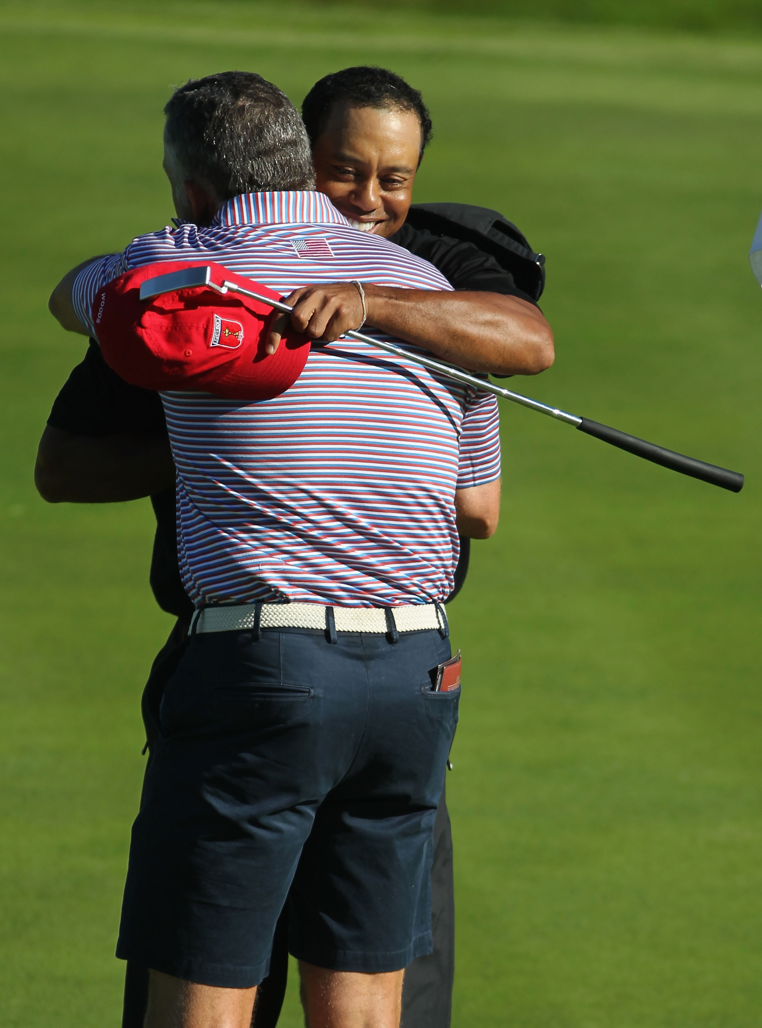 NEWPORT, WALES - OCTOBER 04:  Tiger Woods of the USA hugs his caddie Steve Williams on the 15th green after winning 4&3 in the singles matches during the 2010 Ryder Cup at the Celtic Manor Resort on October 4, 2010 in Newport, Wales.  (Photo by Jamie Squi
