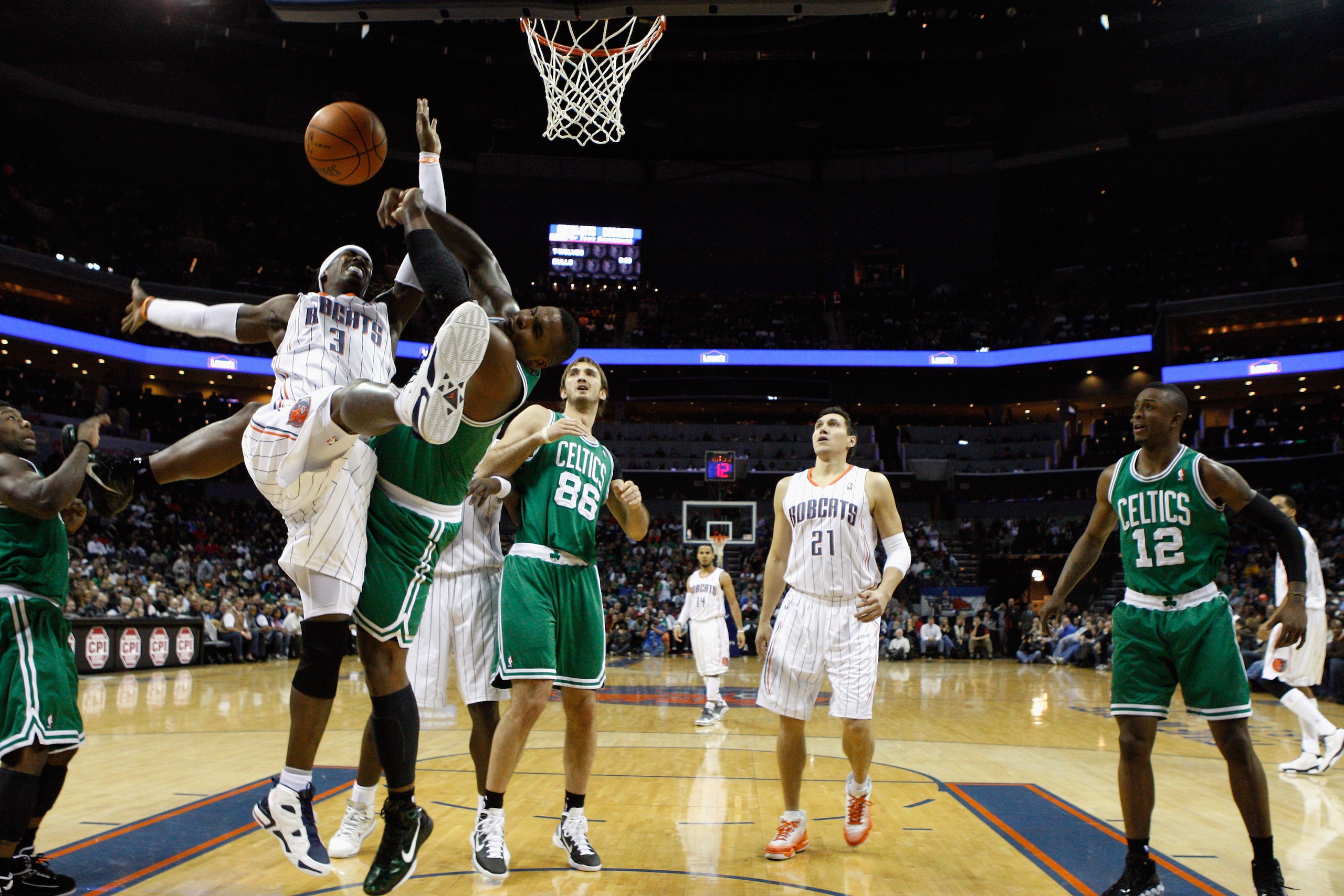 CHARLOTTE, NC - DECEMBER 11:  Glen Davis #11 of the Boston Celtics fouls Gerald Wallace #3 of the Charlotte Bobcats during their game at Time Warner Cable Arena on December 11, 2010 in Charlotte, North Carolina. NOTE TO USER: User expressly acknowledges a
