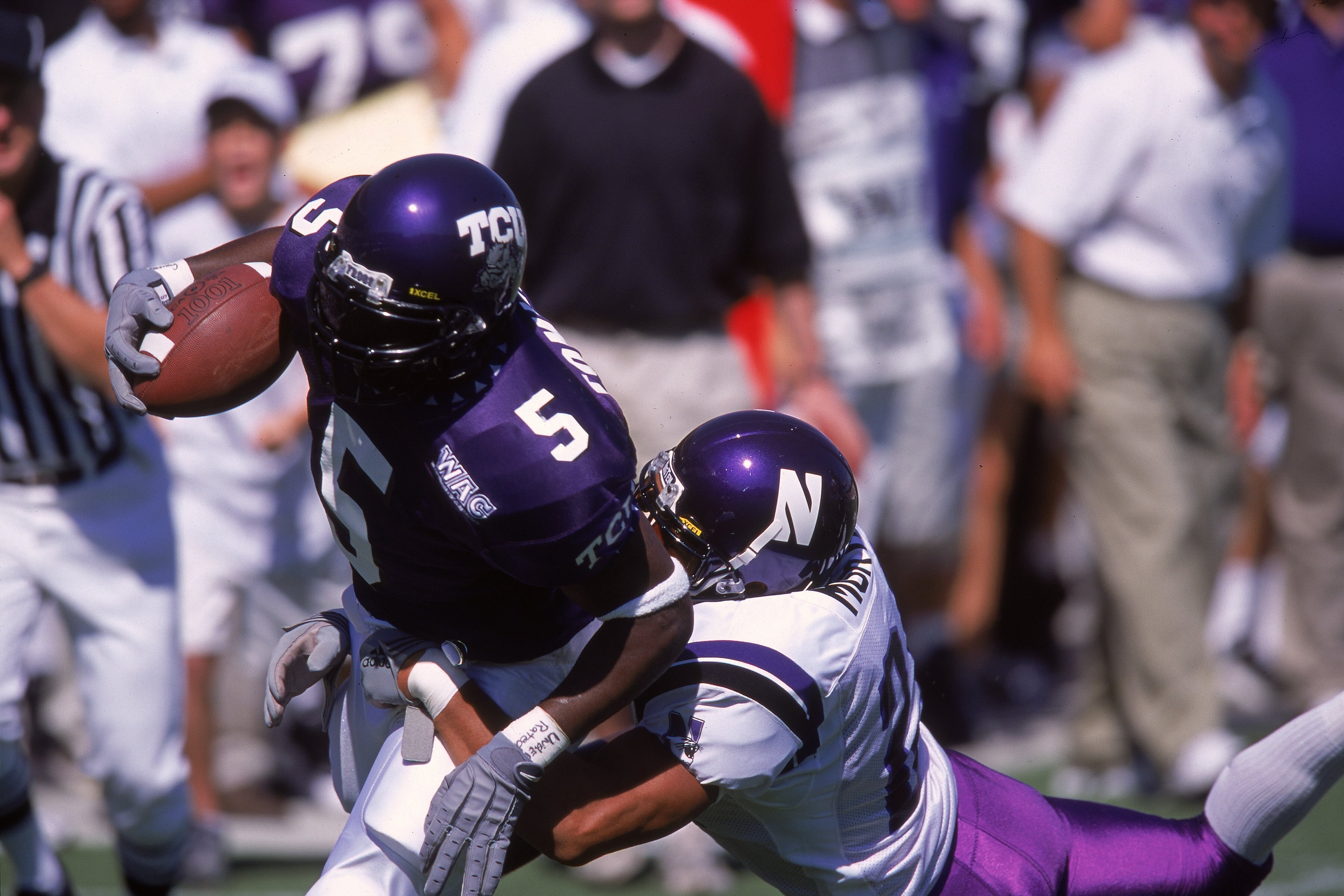 16 Sep 2000:  La Dainian Tomlinson #5 of the Texas Christian University Horned Frogs moves with the ball as Rashad Morton #24 of the Northwestern Wildcats tries to tackle him during the game at the Amon Carter Stadium in Forthworth, Texas. The Horned Frog