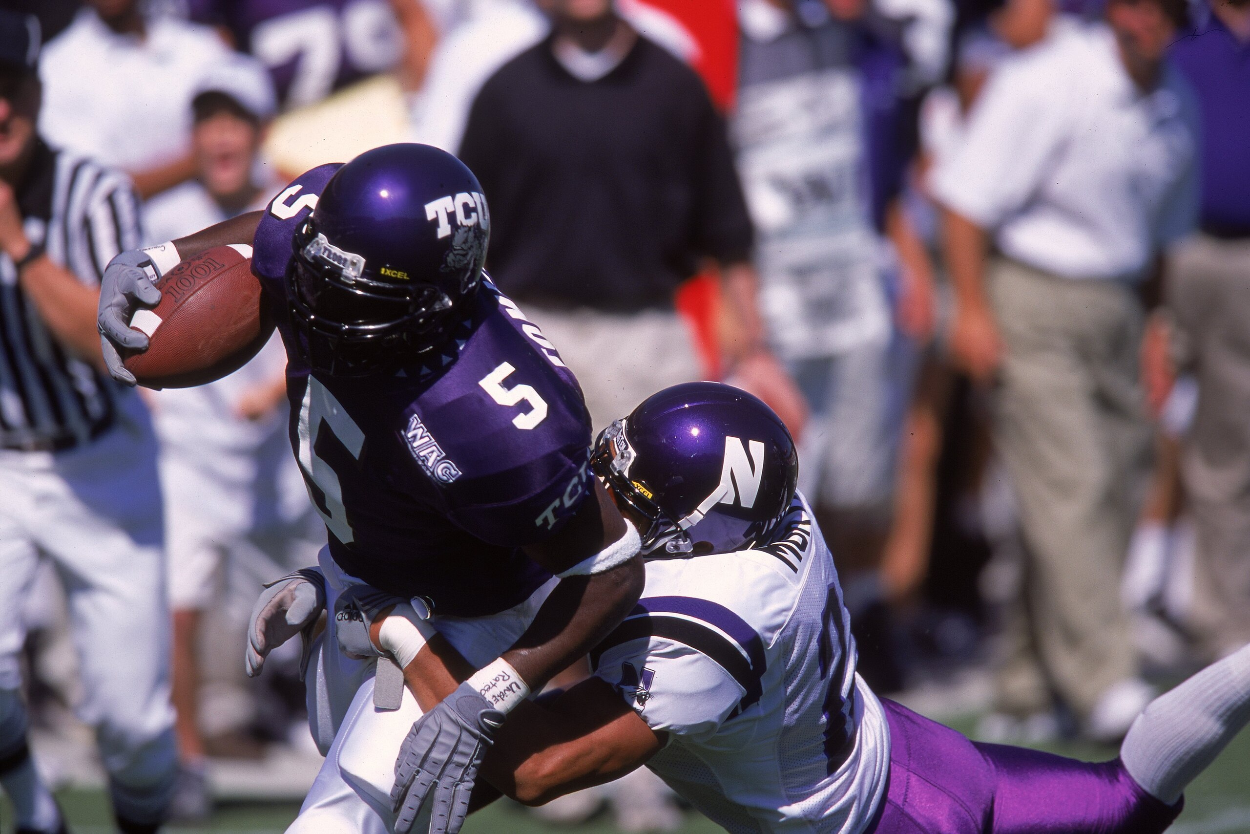 16 Sep 2000:  La Dainian Tomlinson #5 of the Texas Christian University Horned Frogs moves with the ball as Rashad Morton #24 of the Northwestern Wildcats tries to tackle him during the game at the Amon Carter Stadium in Forthworth, Texas. The Horned Frog