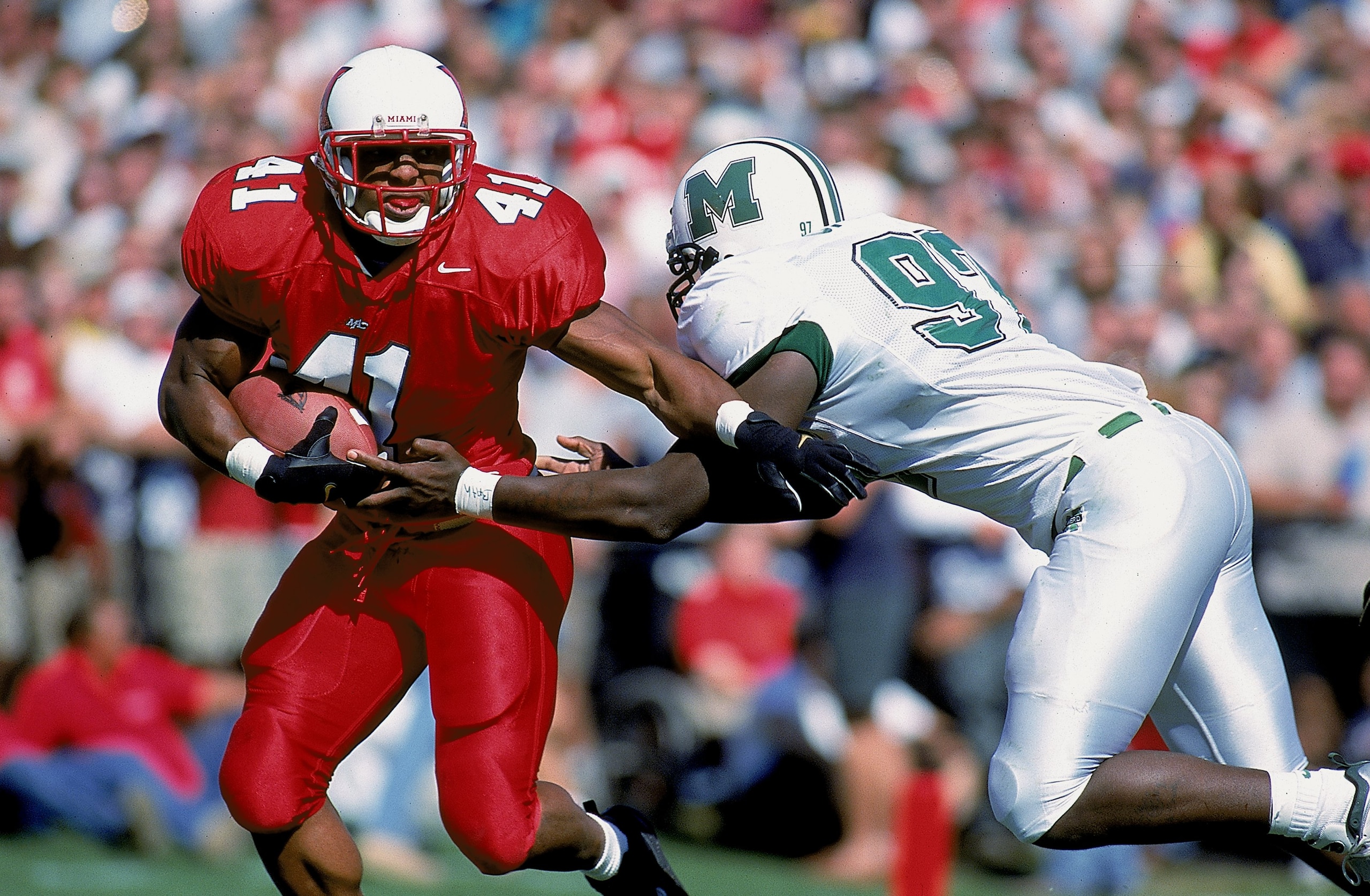 2 Oct 1999:  Travis Prentice #41 of the Miami (OH) Redhawks moves with the ball as Carlos Smith #97 of the Marshall Thundering Herd tries to tackle him during the game at Yager Stadium in Oxford, Ohio. The Thundering Herd defeated the Redhawks 32-14. Mand