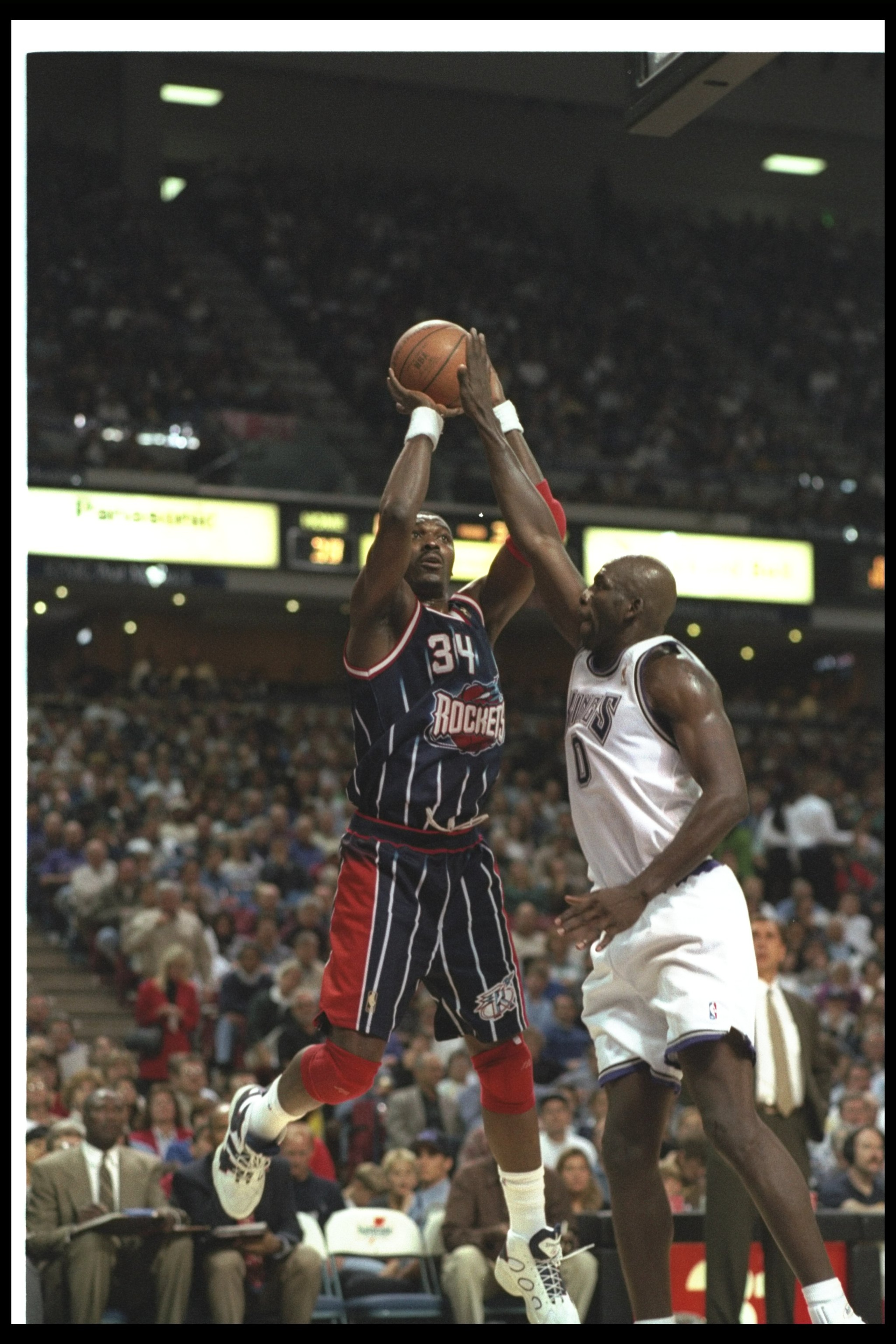 5 Nov 1996:  Center Hakeem Olajuwon of the Houston Rockets (left) goes up to shoot the ball as forward Olden Polynice of the Sacramento Kings attempts to block him during a game at ARCO Arena in Sacramento, California.  The Rockets won the game, 102-80.
