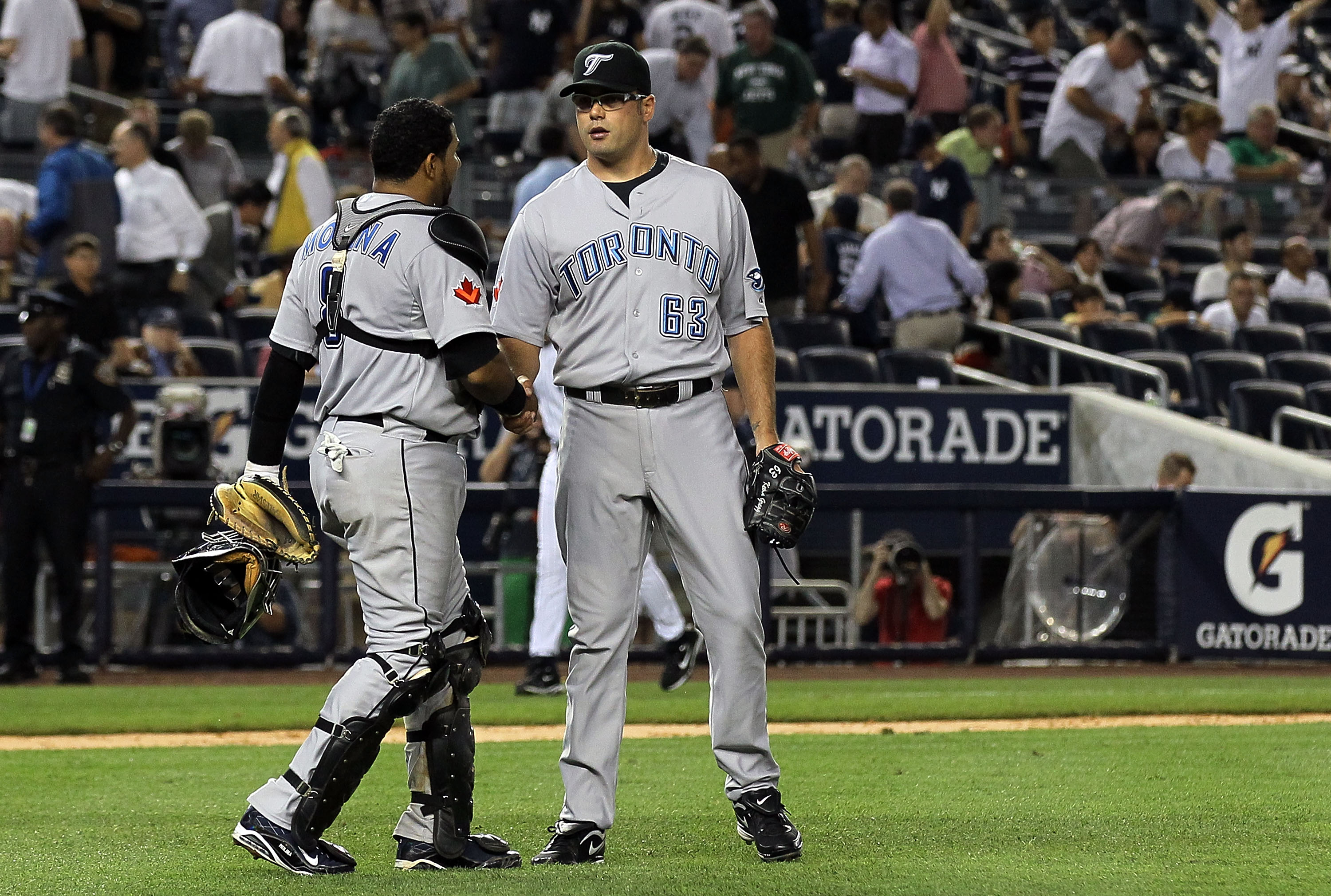 NEW YORK - AUGUST 02:  Jose Molina #8 and Kevin Gregg #63 of the Toronto Blue Jays celebrate after defeating the New York Yankees on August 2, 2010 at Yankee Stadium in the Bronx borough of New York City.  (Photo by Jim McIsaac/Getty Images)
