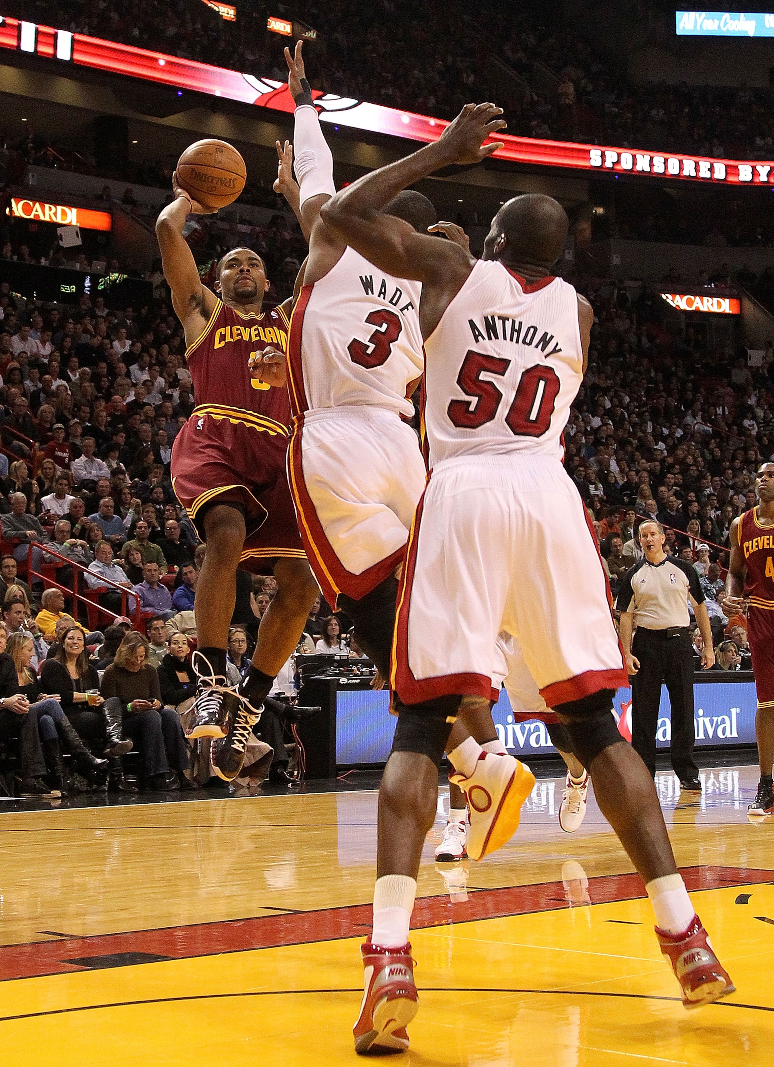 MIAMI, FL - DECEMBER 15:  Ramon Sessions #3 of the Cleveland Cavaliersshoots over Dwyane Wade #3 and  Joel Anthony #50 of the Miami Heat during a game at American Airlines Arena on December 15, 2010 in Miami, Florida. NOTE TO USER: User expressly acknowle