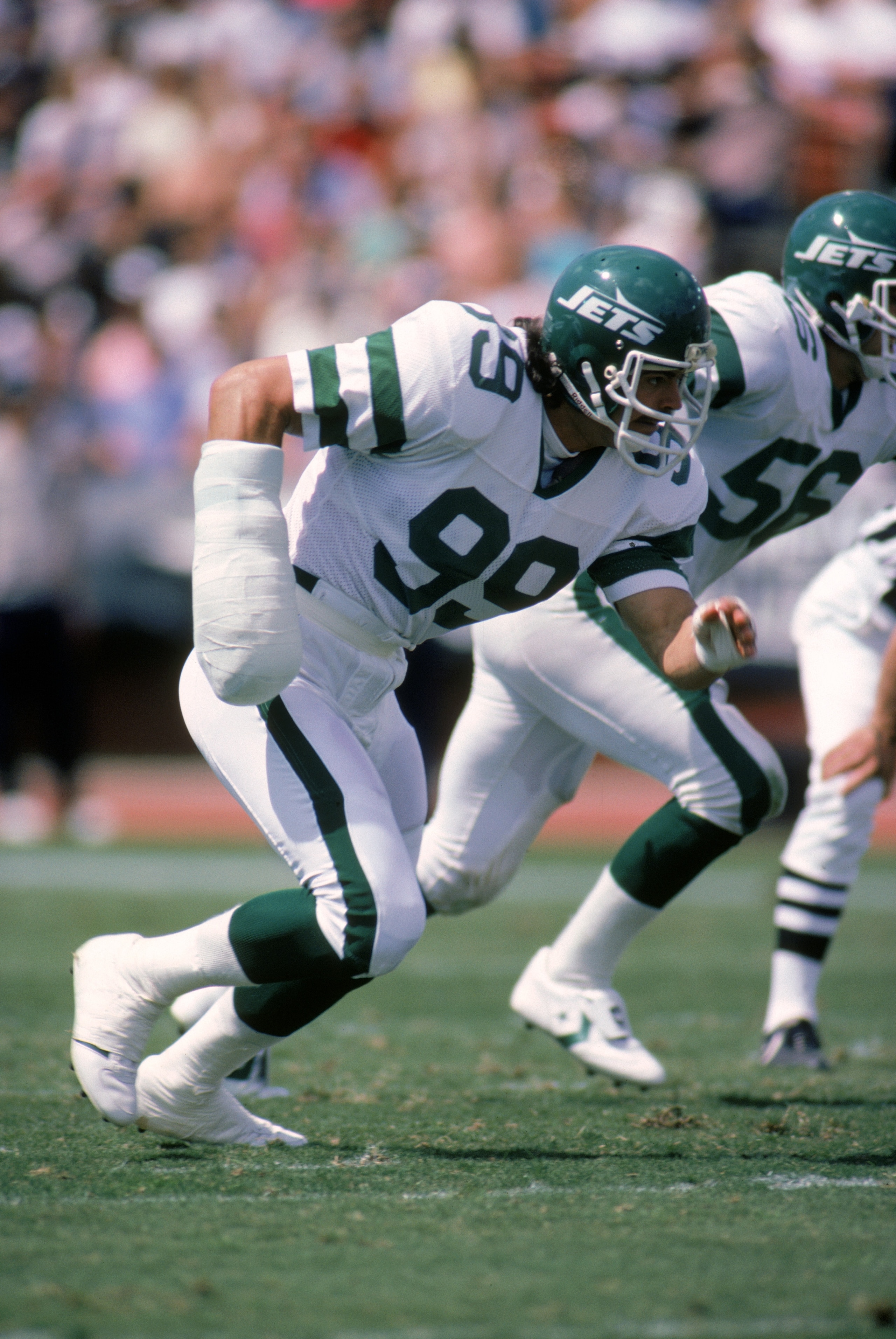 1985:  Defensive end Mark Gastineau #99 of the New York Jets wears a cast on his right arm as he runs on the field during a game in 1985.  (Photo by Rick Stewart/Getty Images)