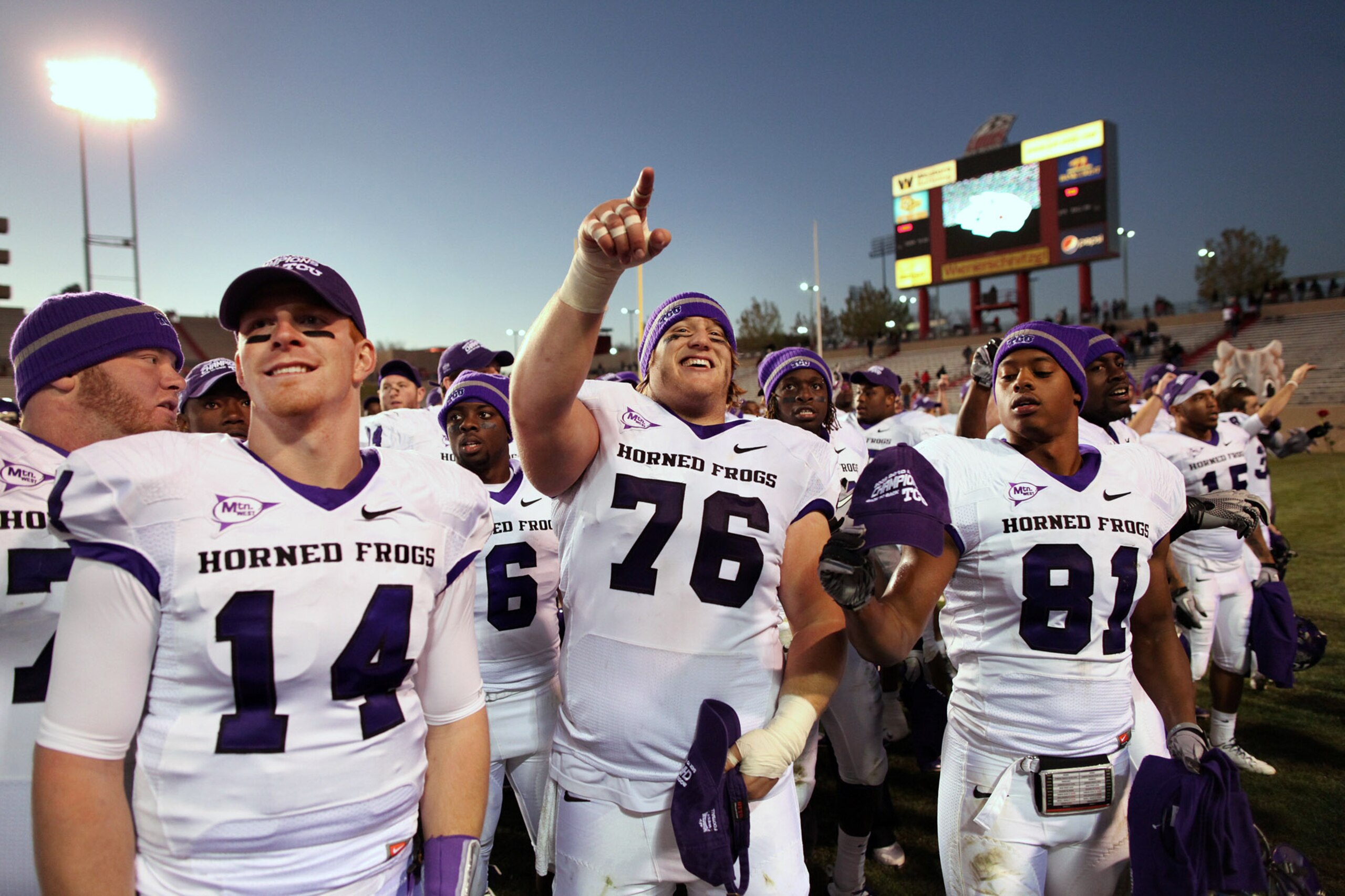 ALBUQUERQUE, NM - NOVEMBER 27: TCU Horned Frogs quarterback Andy Dalton #14, center Jake Kirkpatrick #76 and wide receiver Alonzo Adams #81 celebrate their 66-17 win over the University of New Mexico Lobos on November 27, 2010 at University Stadium in Alb