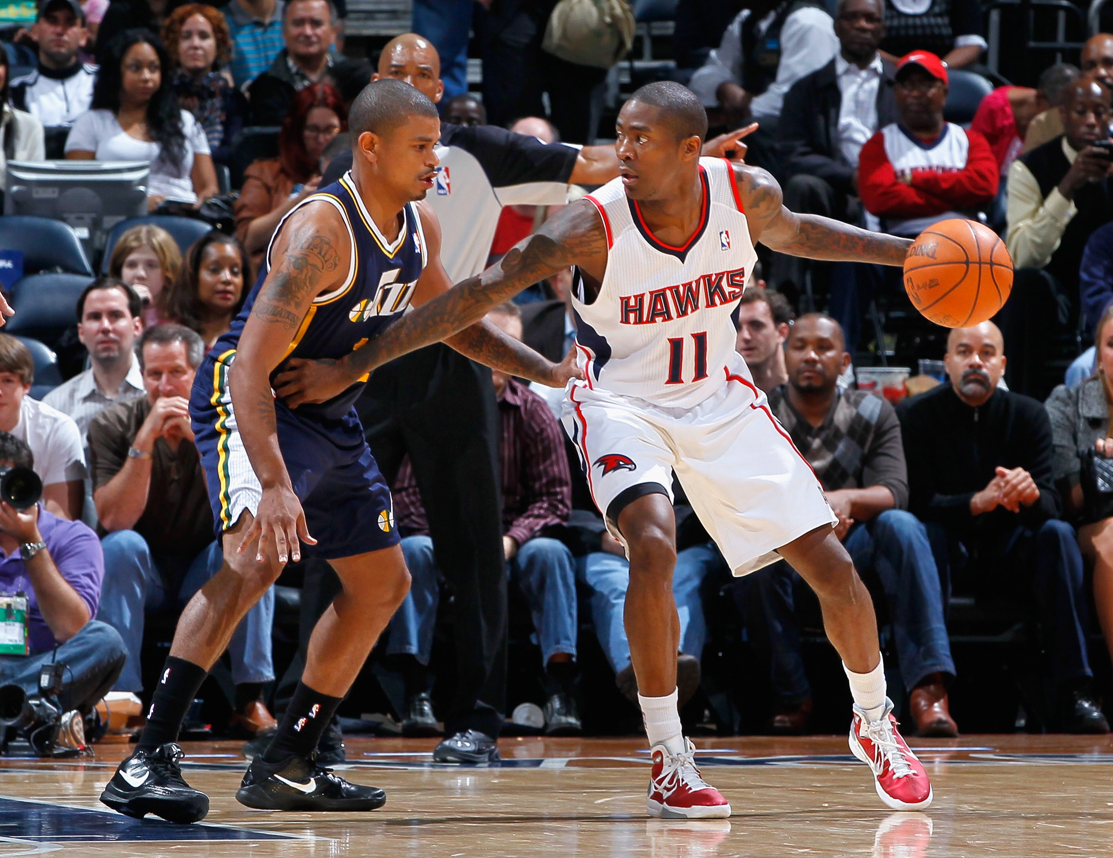 ATLANTA - NOVEMBER 12:  Jamal Crawford #11 of the Atlanta Hawks against Earl Watson #11 of the Utah Jazz at Philips Arena on November 12, 2010 in Atlanta, Georgia.  NOTE TO USER: User expressly acknowledges and agrees that, by downloading and/or using thi
