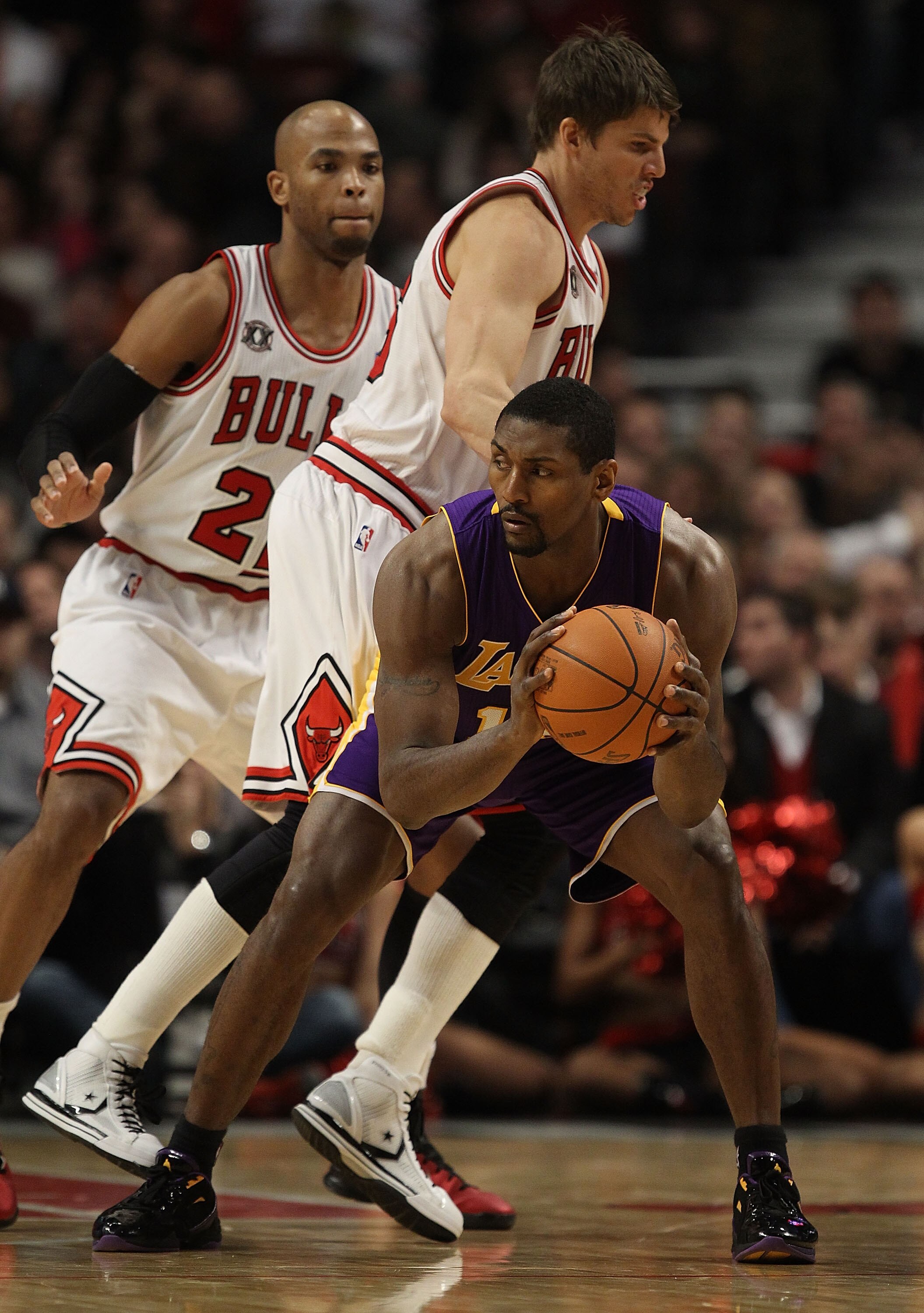 CHICAGO, IL - DECEMBER 10: Ron Artest #15 of the Los Angeles Lakers looks to pass as Kyle Korver #26 and Taj Gibson #22 of the Chicago Bulls defend at the United Center on December 10, 2010 in Chicago, Illinois. The Bulls defeated the Lakers 88-84. NOTE T