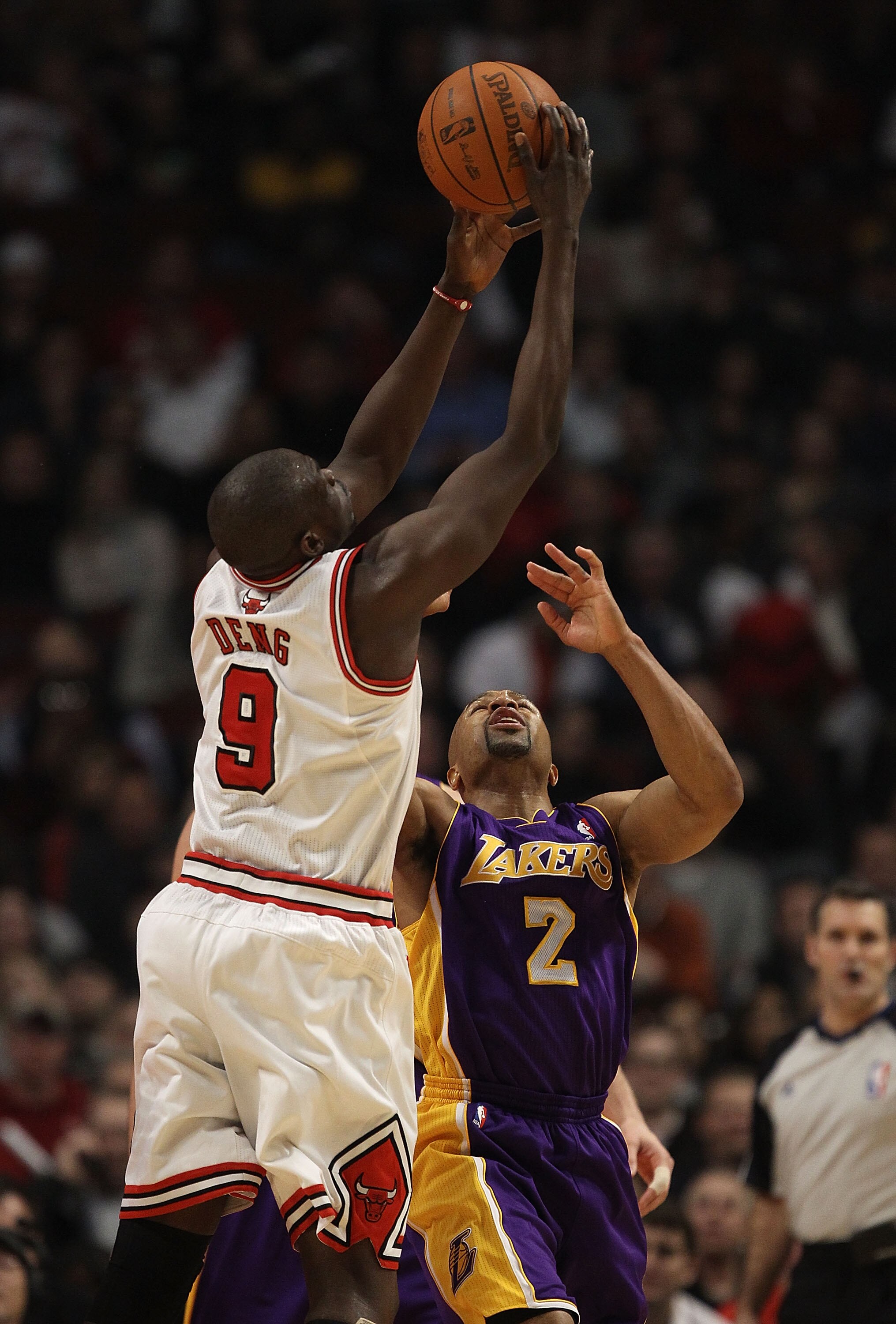 CHICAGO, IL - DECEMBER 10: Loul Deng #9 of the Chicago Bulls leaps for a rebound over Derek Fisher #2 of the Los Angeles Lakers at the United Center on December 10, 2010 in Chicago, Illinois. The Bulls defeated the Lakers 88-84. NOTE TO USER: User express
