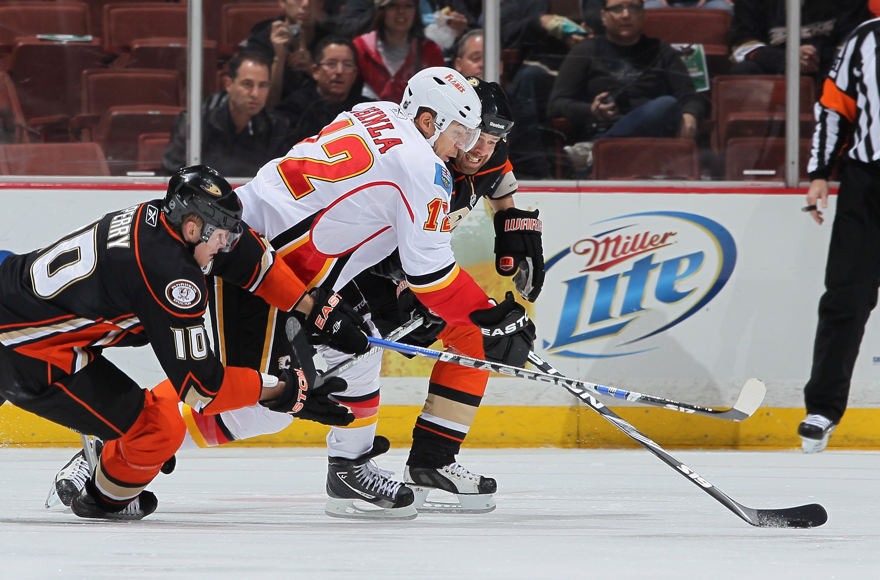 ANAHEIM, CA - DECEMBER 10:  Jerome Iginla #12 of the Calgary Flames is pursued by Corey Perry (L) #10 and Paul Mara #23 of the Anaheim Ducks at the Honda Center on December 10, 2010 in Anaheim, California.  (Photo by Jeff Gross/Getty Images)