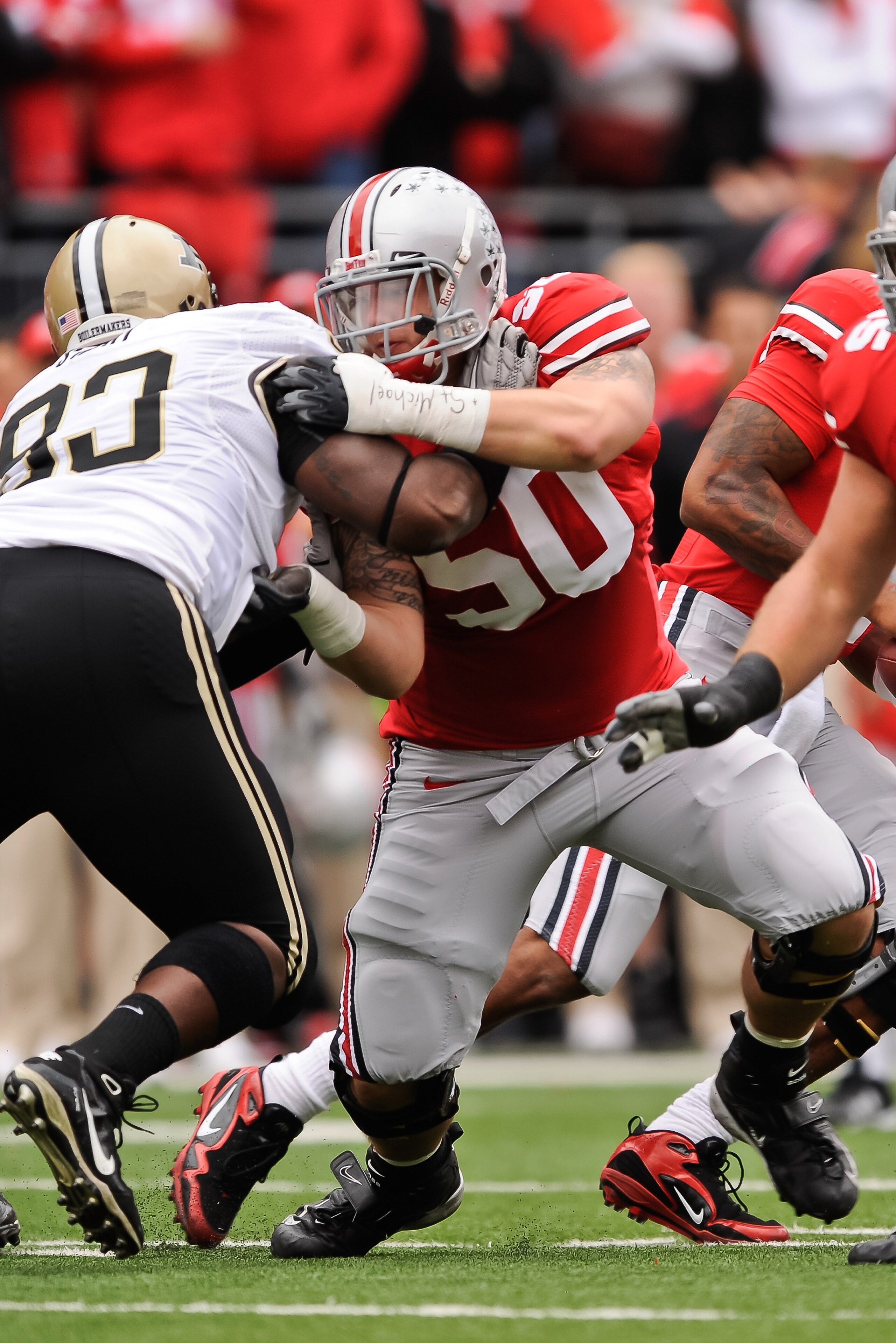 COLUMBUS, OH - OCTOBER 23:  Michael Brewster #50 of the Ohio State Buckeyes blocks against the Purdue Boilermakers at Ohio Stadium on October 23, 2010 in Columbus, Ohio.  (Photo by Jamie Sabau/Getty Images)